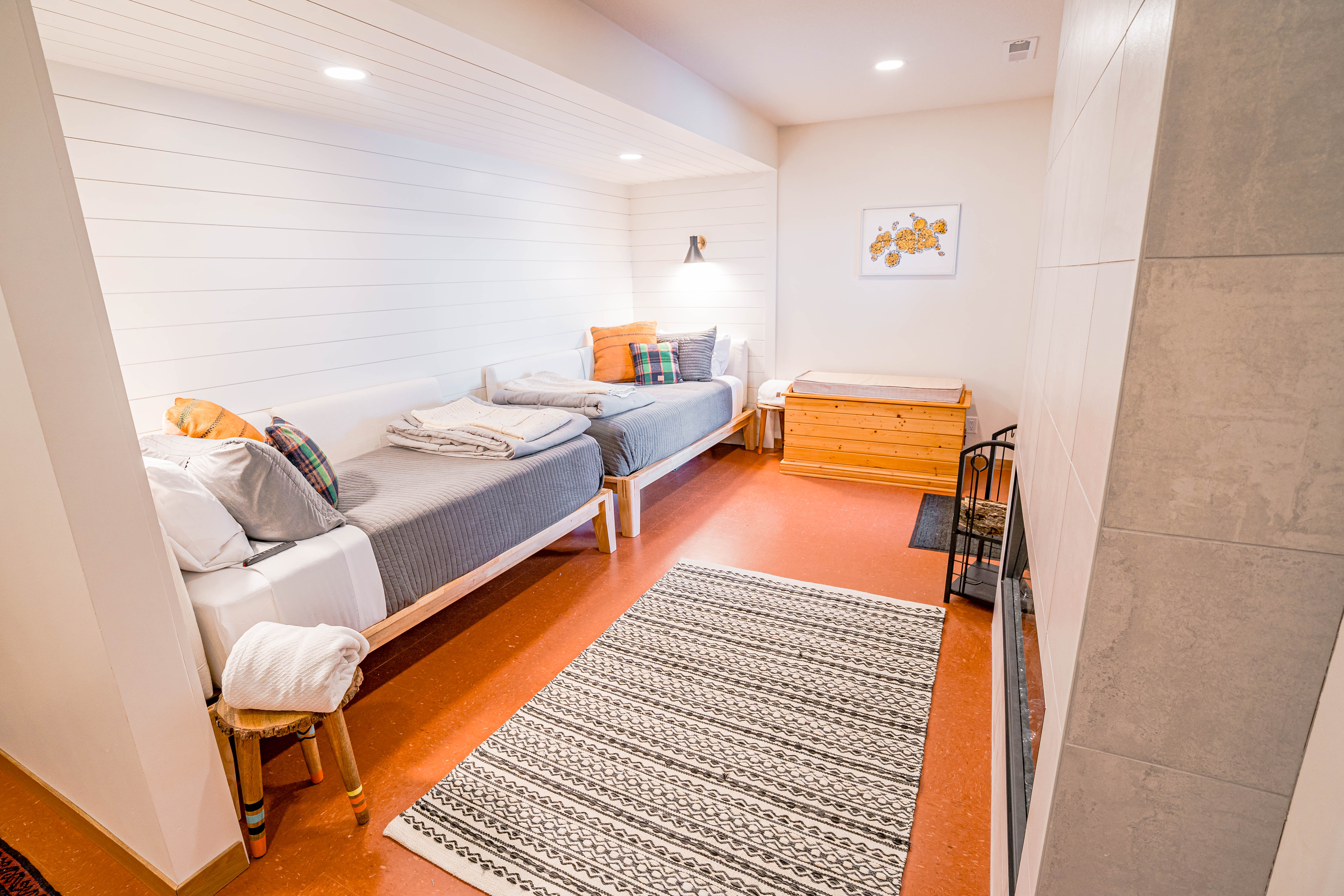 A cozy and inviting bedroom featuring two single beds and warm decor.