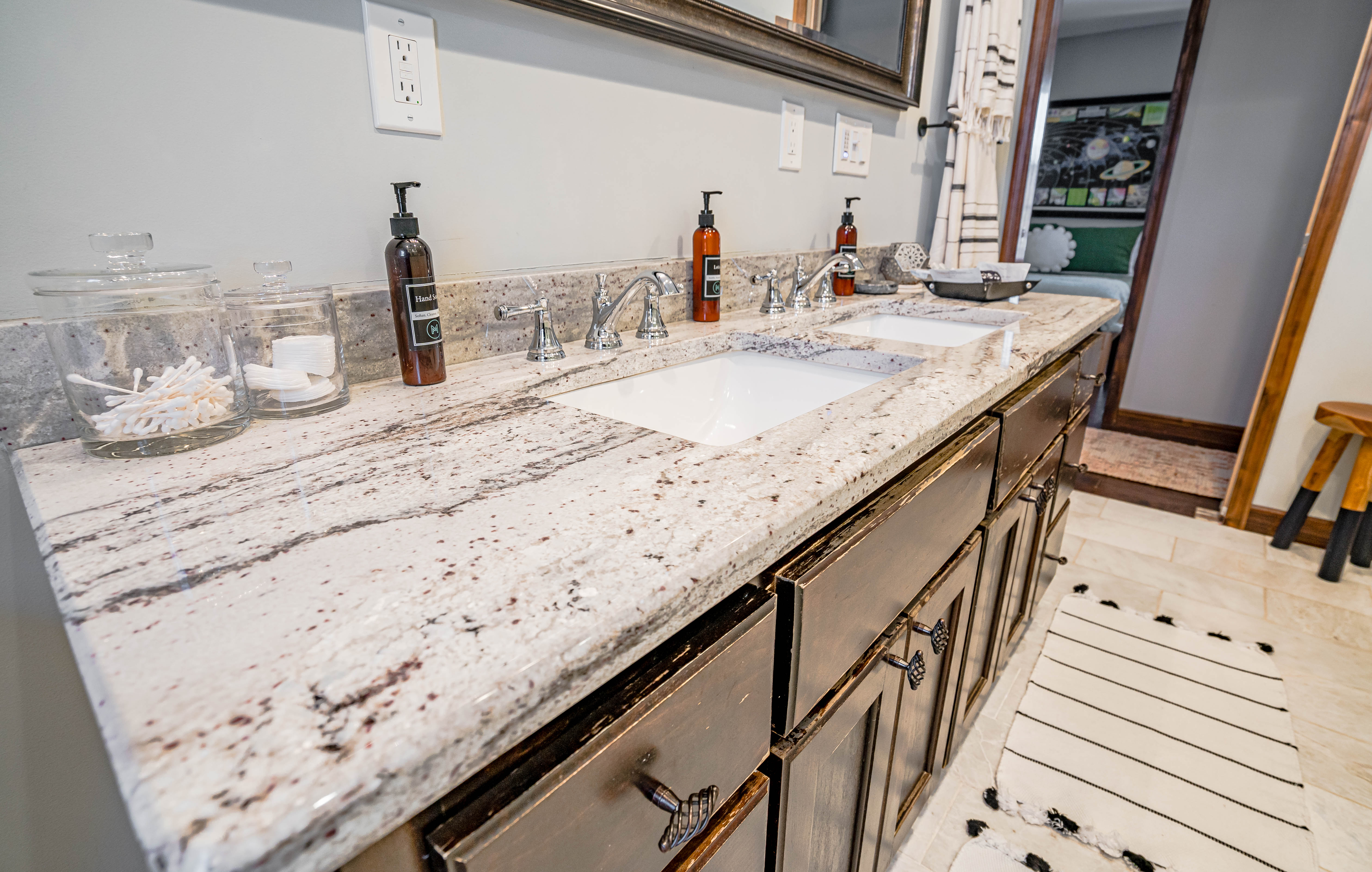 Stylish bathroom vanity with granite countertop and modern fixtures.