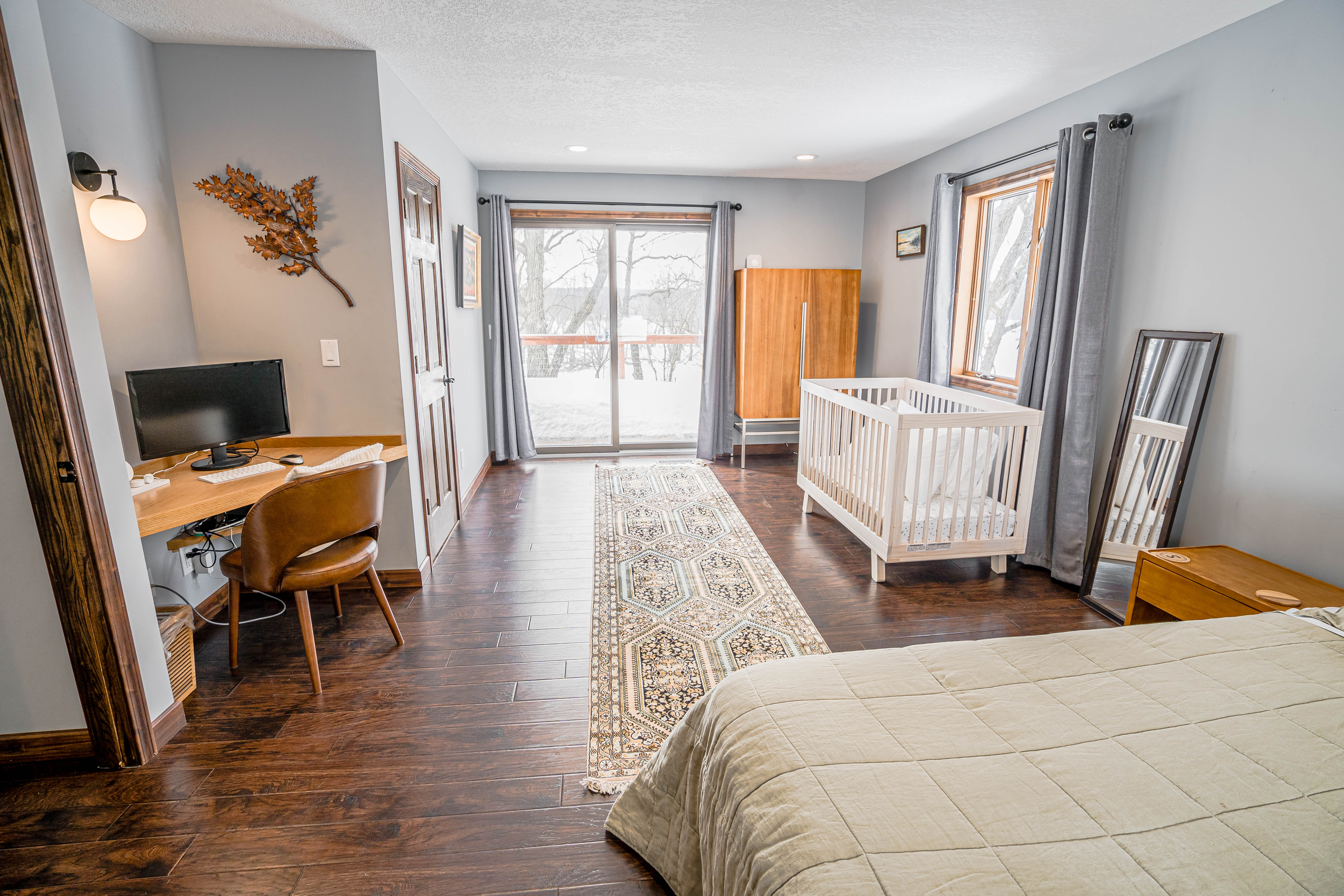 A warm and inviting bedroom featuring modern décor and a snowy view.