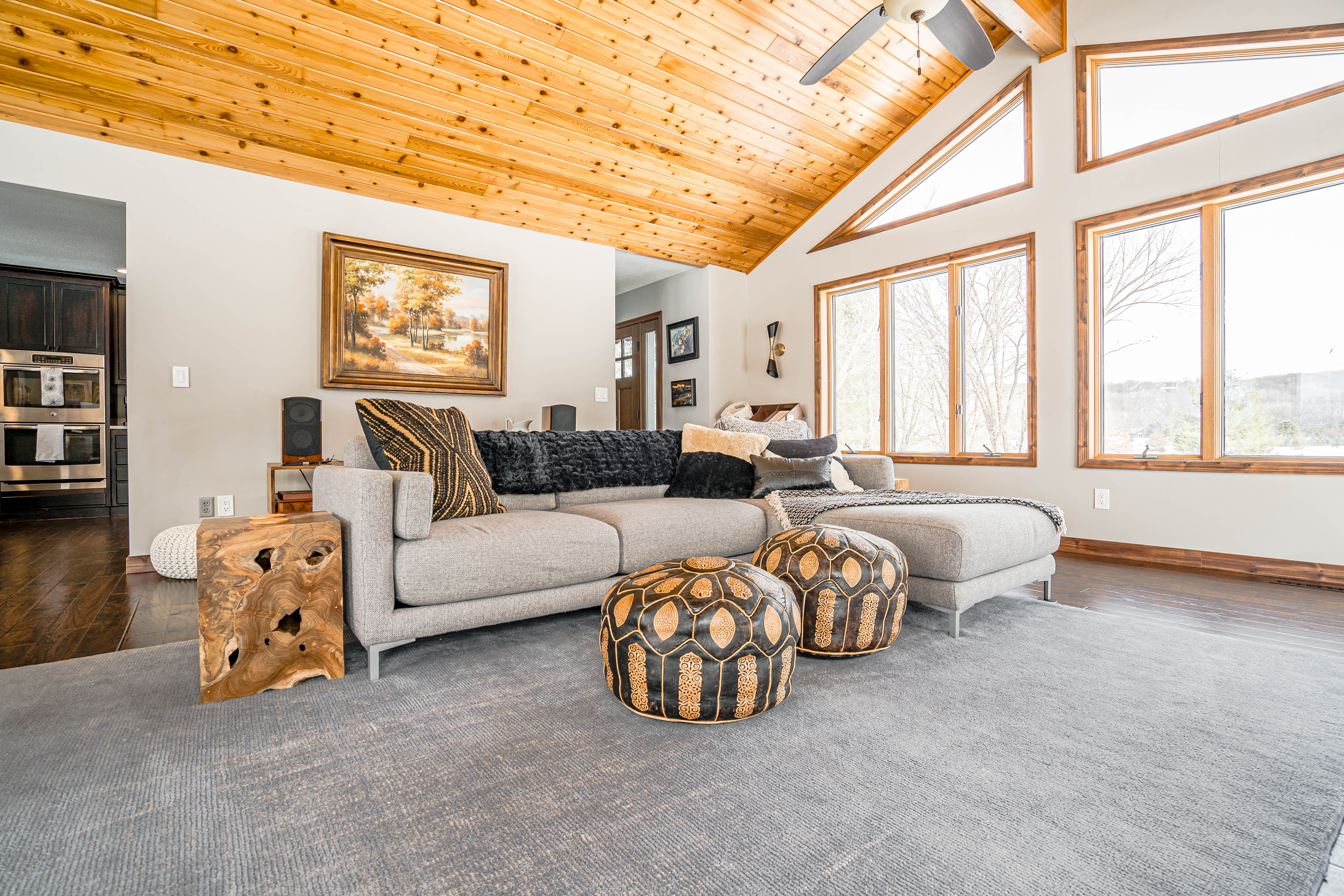 A modern living room with a vaulted ceiling and cozy furnishings.