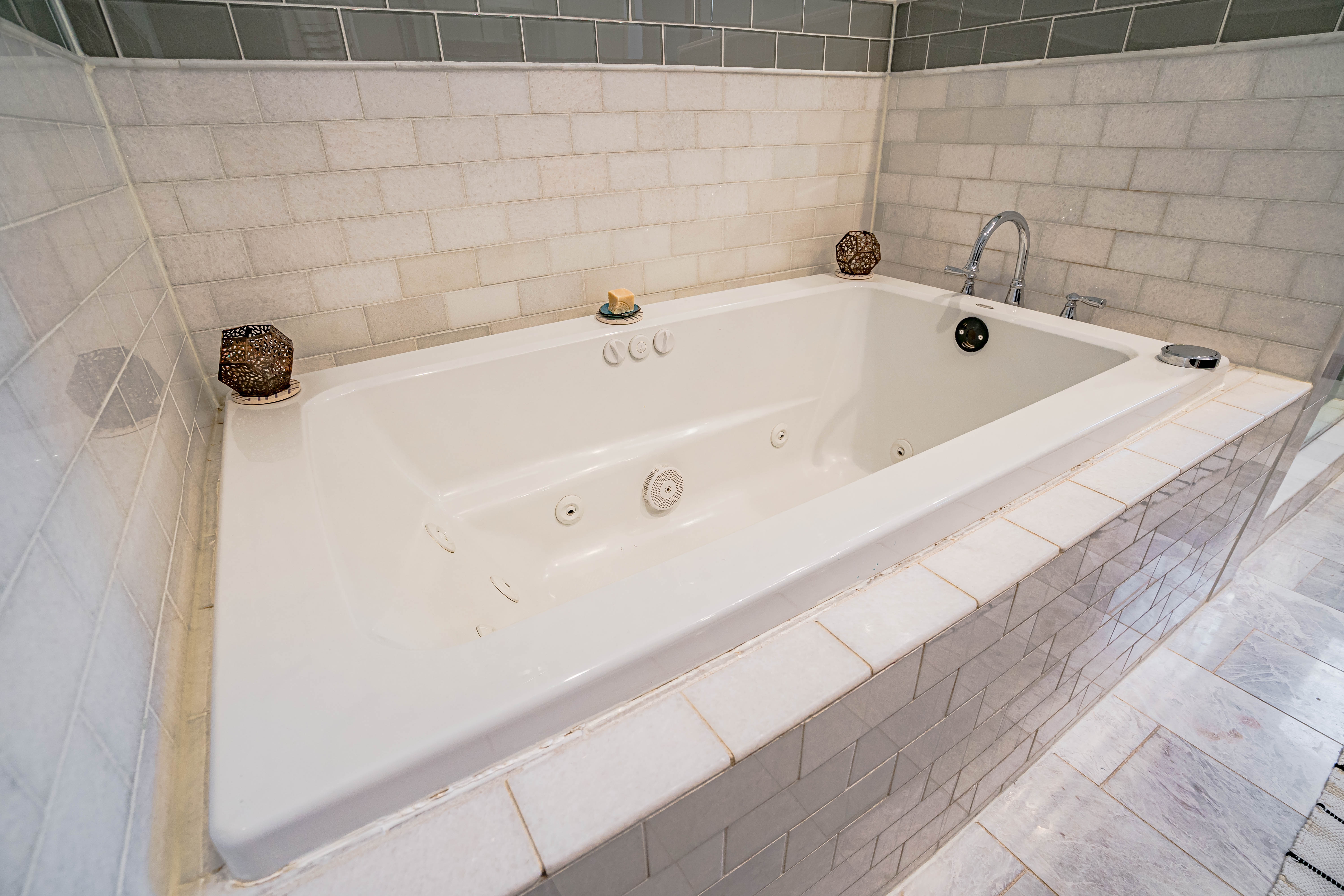 A modern bathtub with intricate decor in a stylish bathroom.