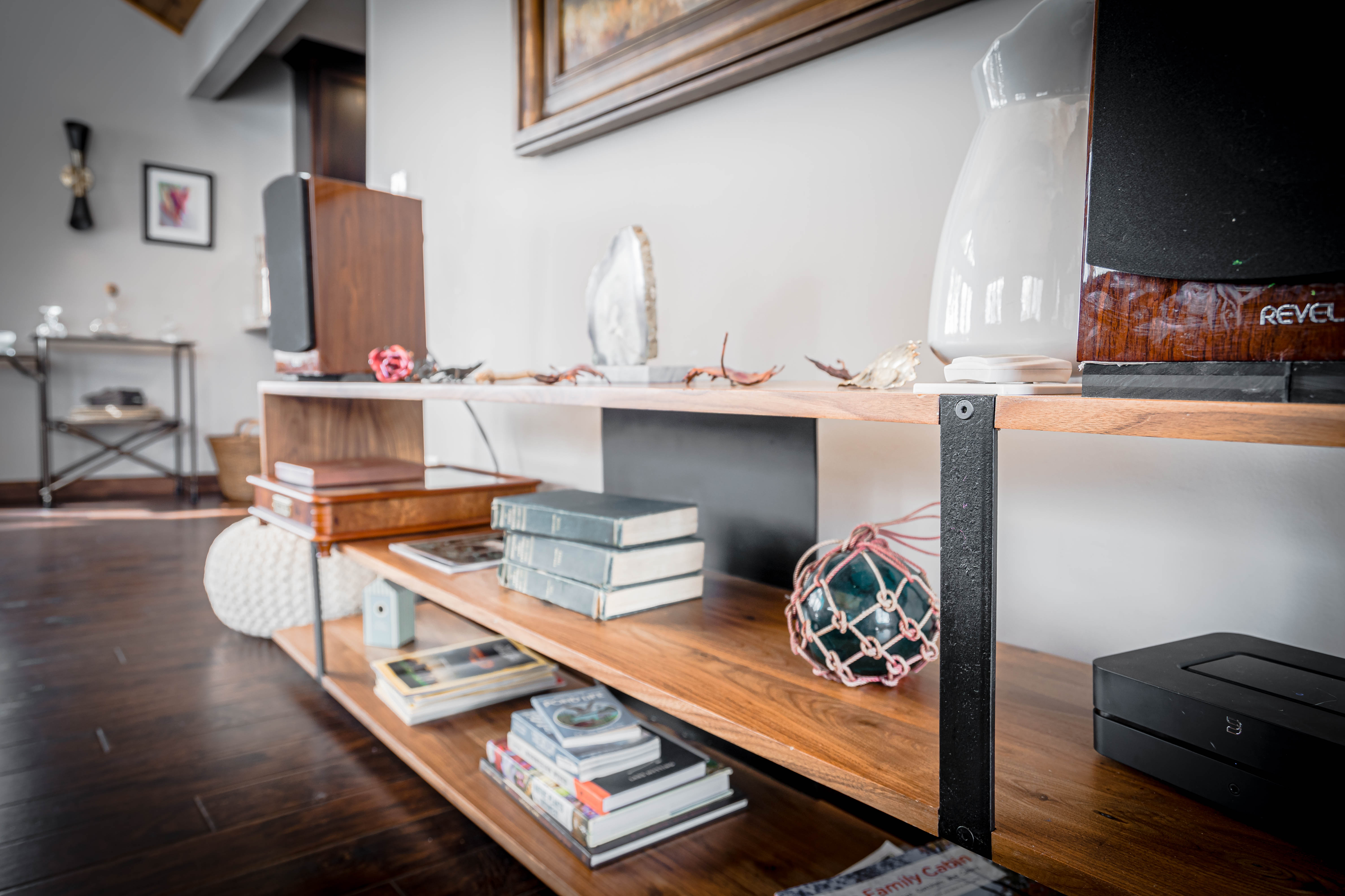 Stylish wooden shelf unit showcasing decor and books in a modern interior.