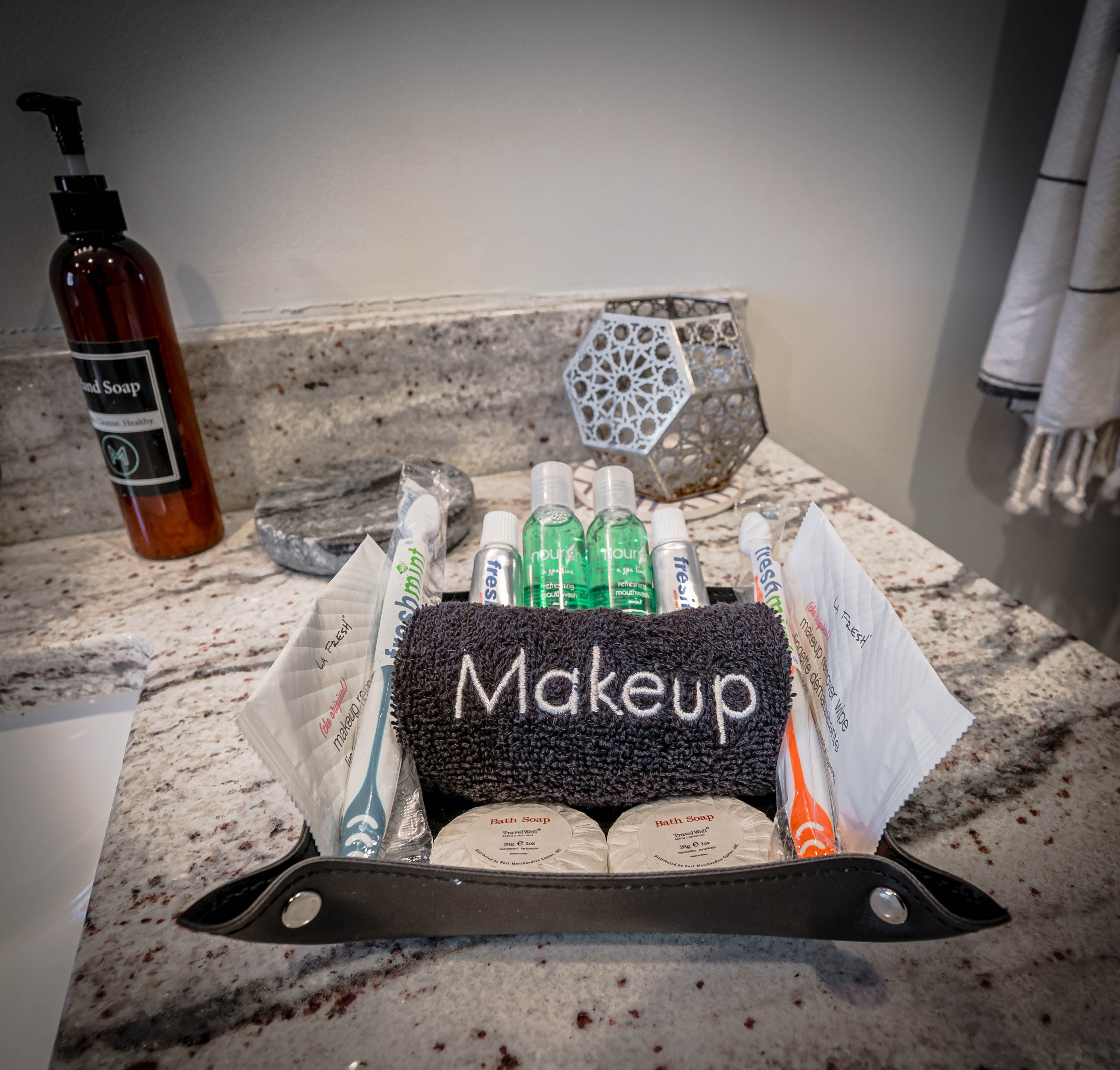 A well-organized bathroom counter featuring make-up essentials and toiletries.
