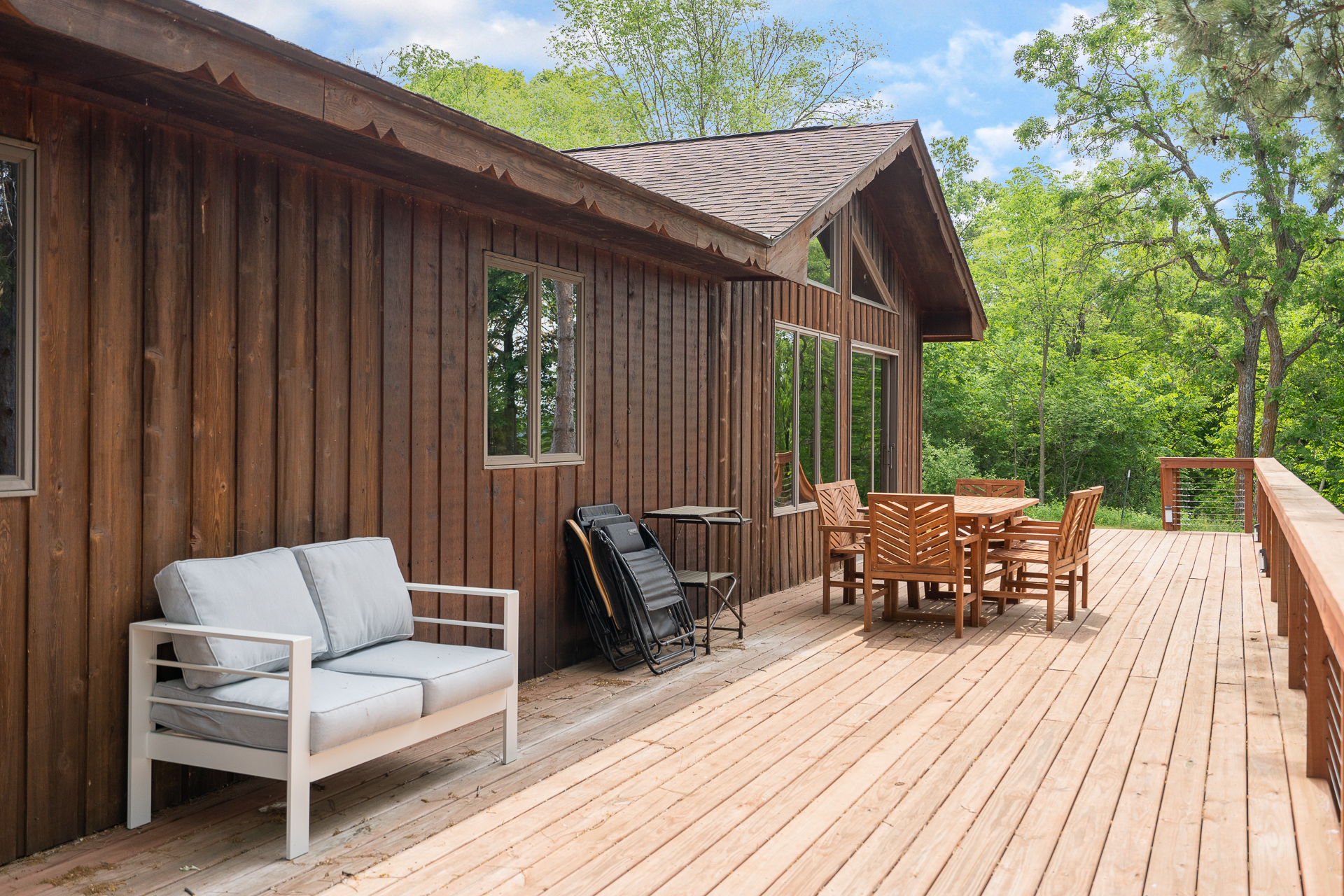 A cozy wooden deck with seating, perfect for outdoor relaxation.