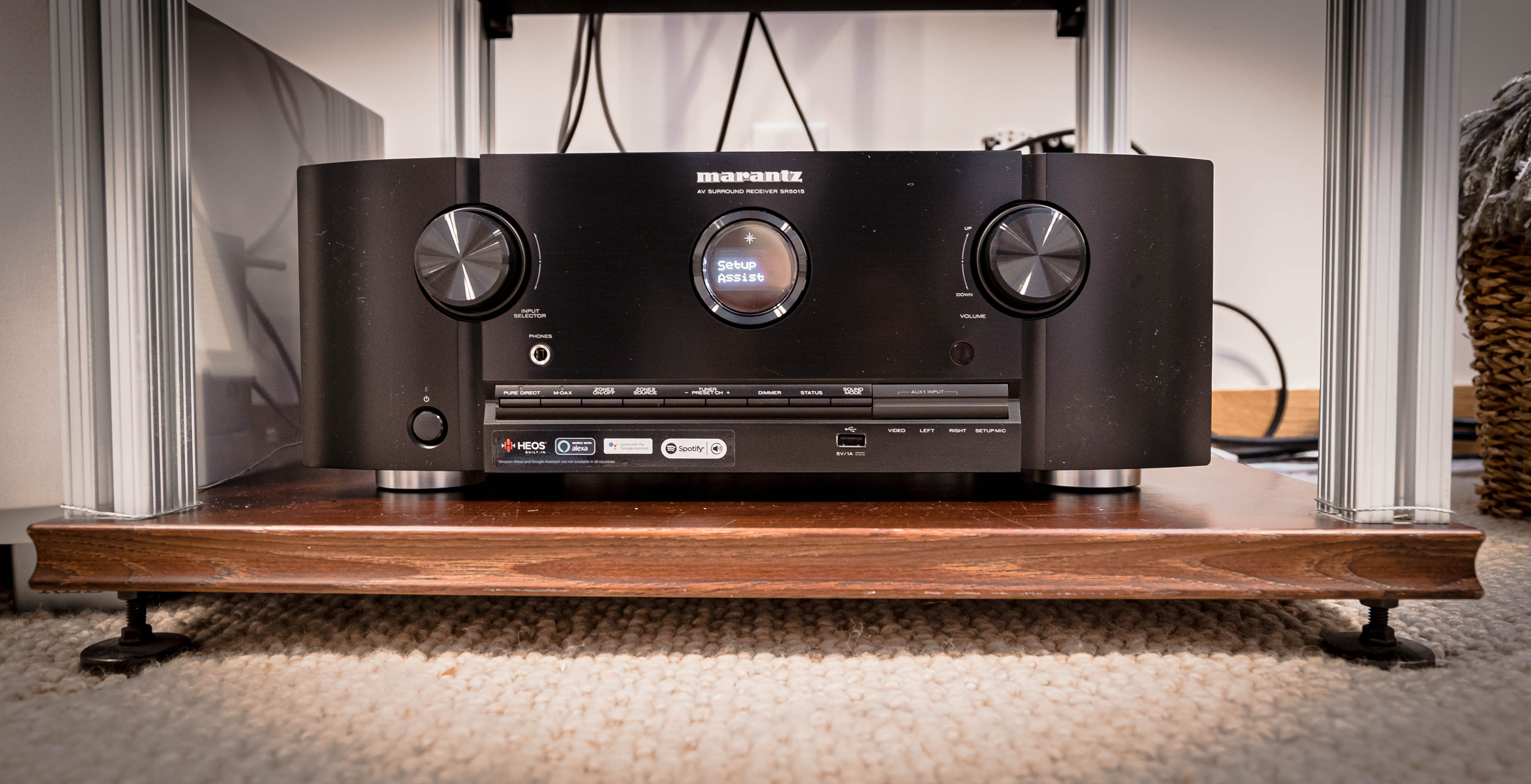 A stylish Marantz AV surround receiver on a wooden shelf.