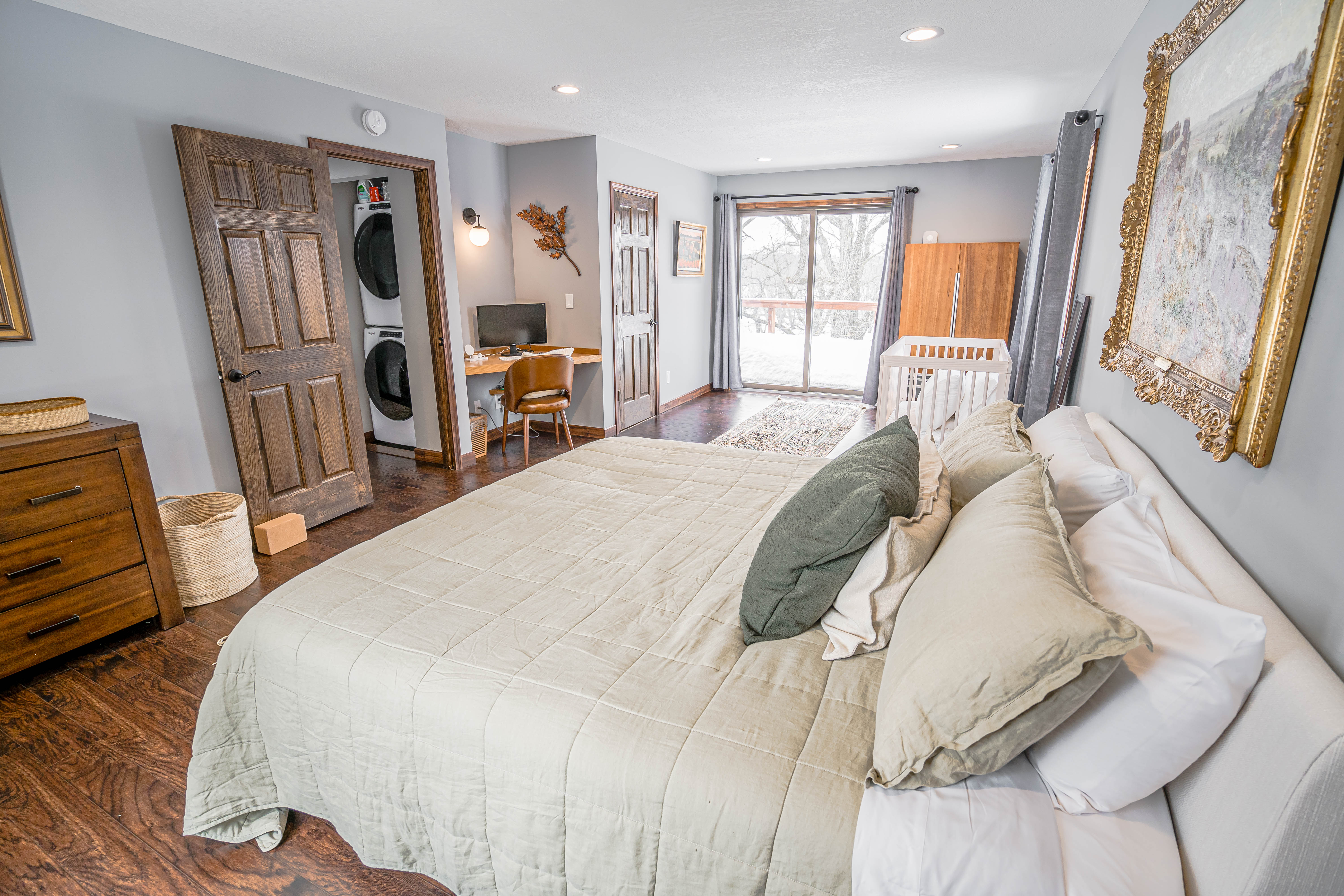 A stylish and cozy bedroom with modern touches and a snowy view outside.