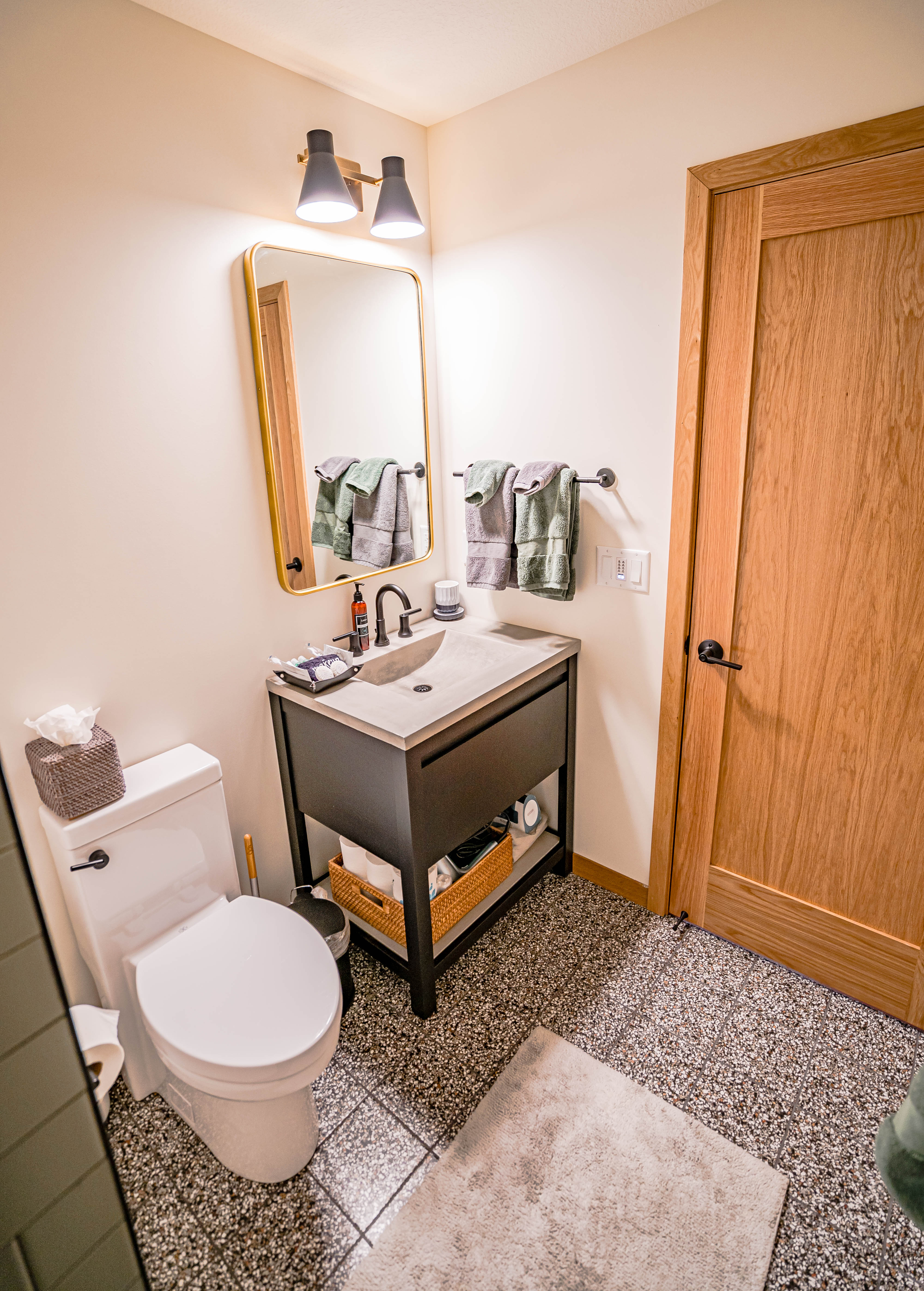A modern bathroom featuring a sleek vanity and stylish decor.