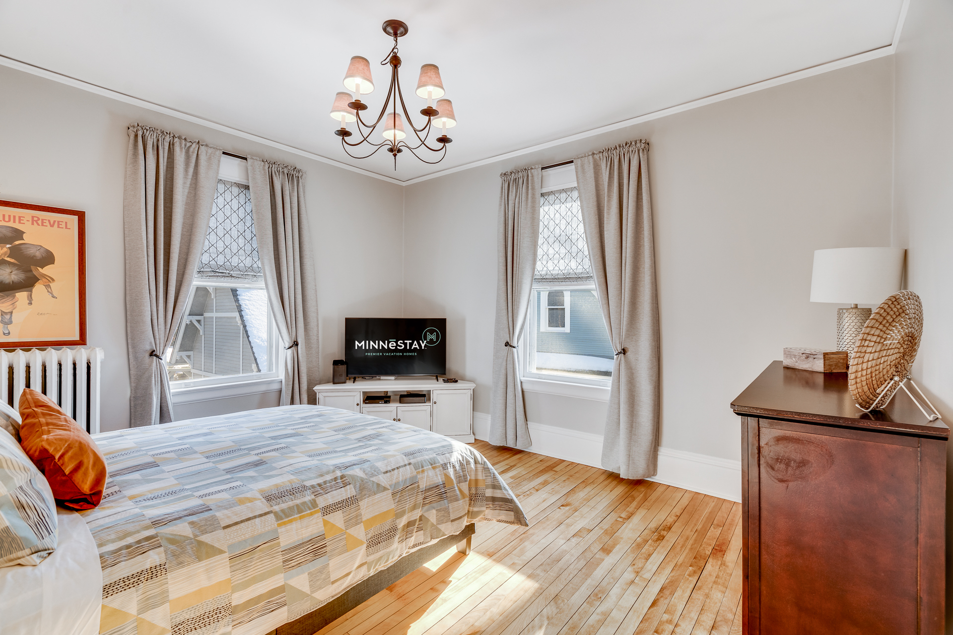 A bright and welcoming bedroom featuring a cozy bed and modern decor.