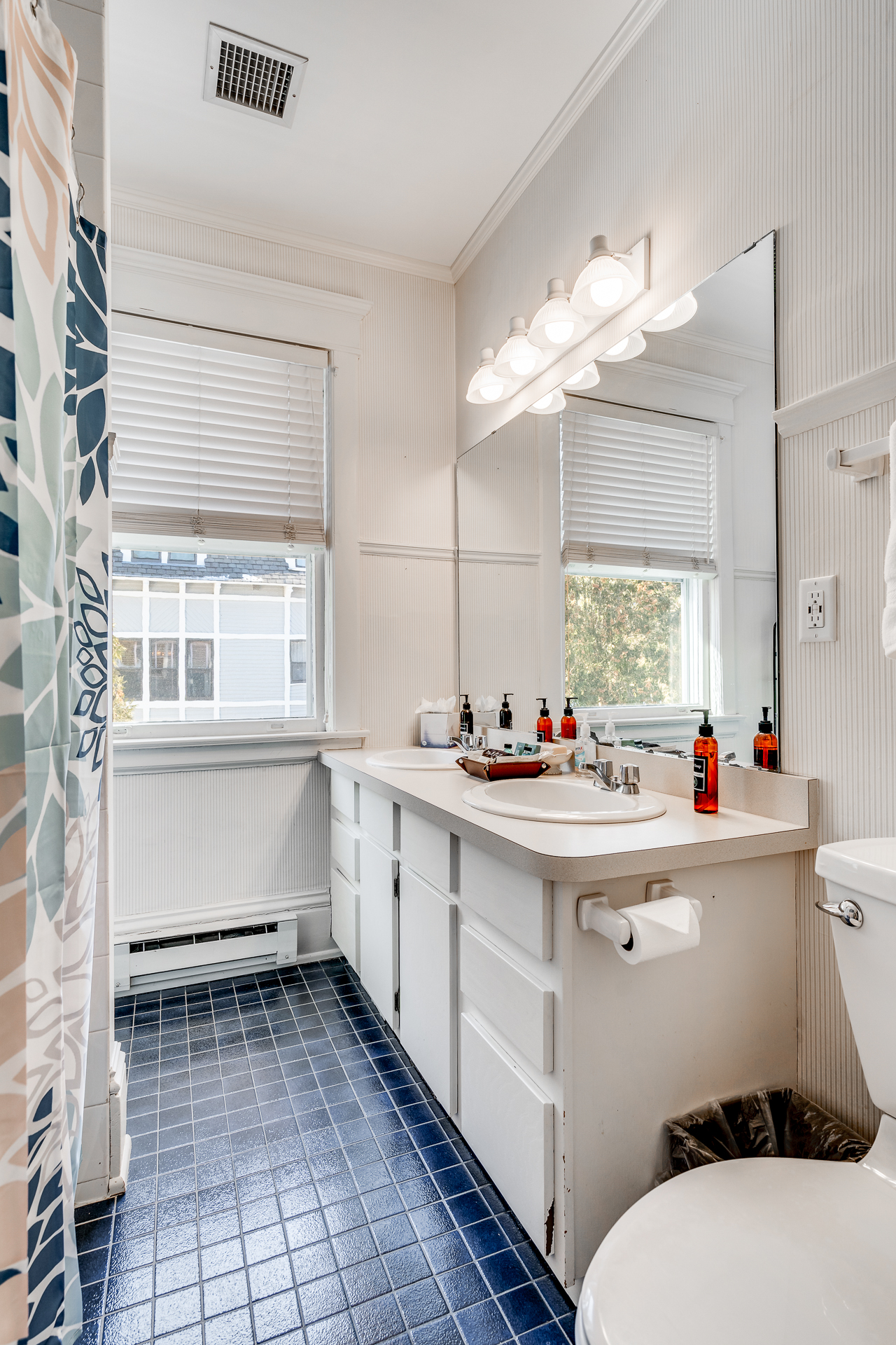 Bright and tidy bathroom with dual sinks and modern decor.