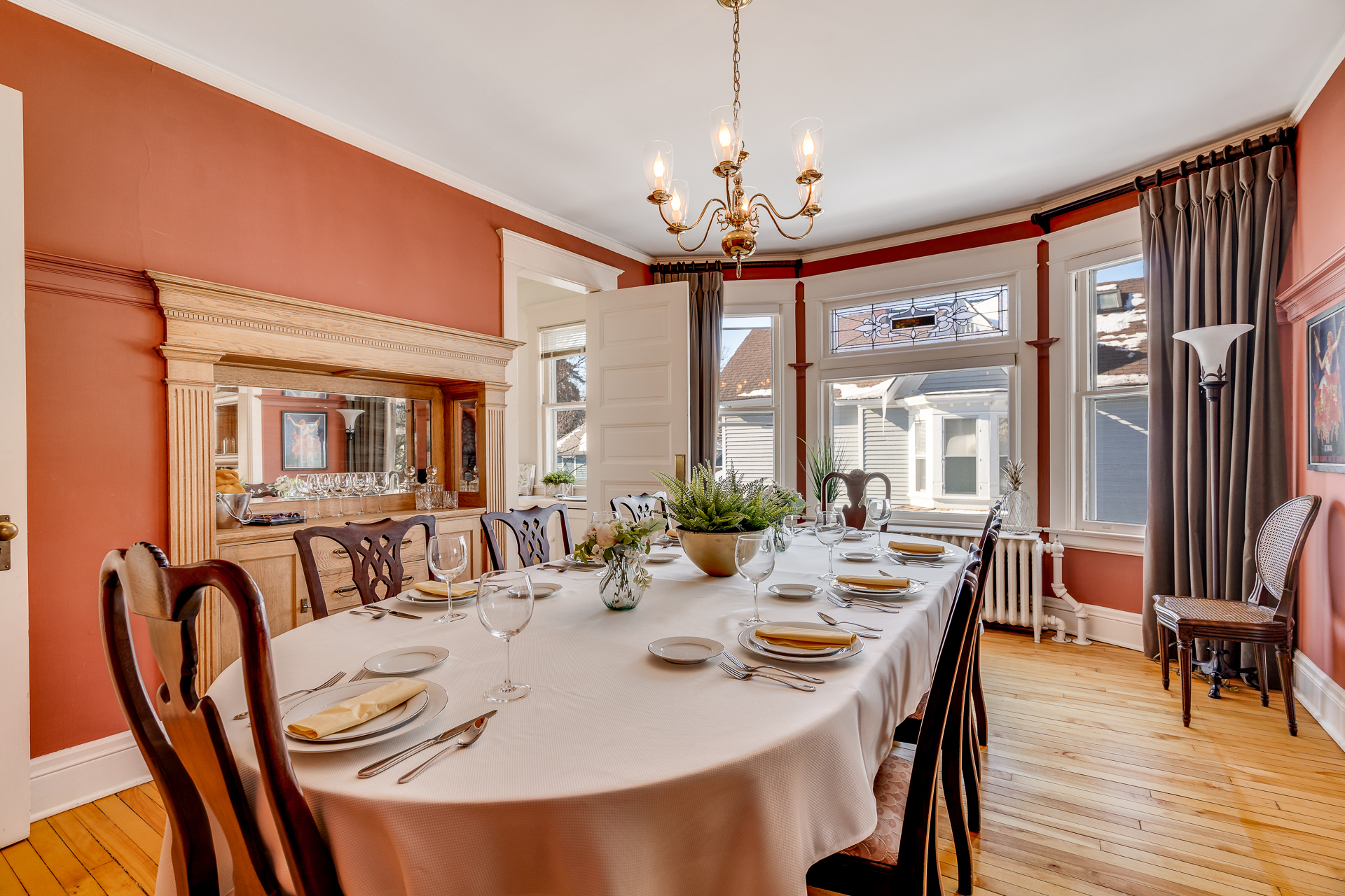 Elegant dining room featuring a beautifully set table and warm decor.
