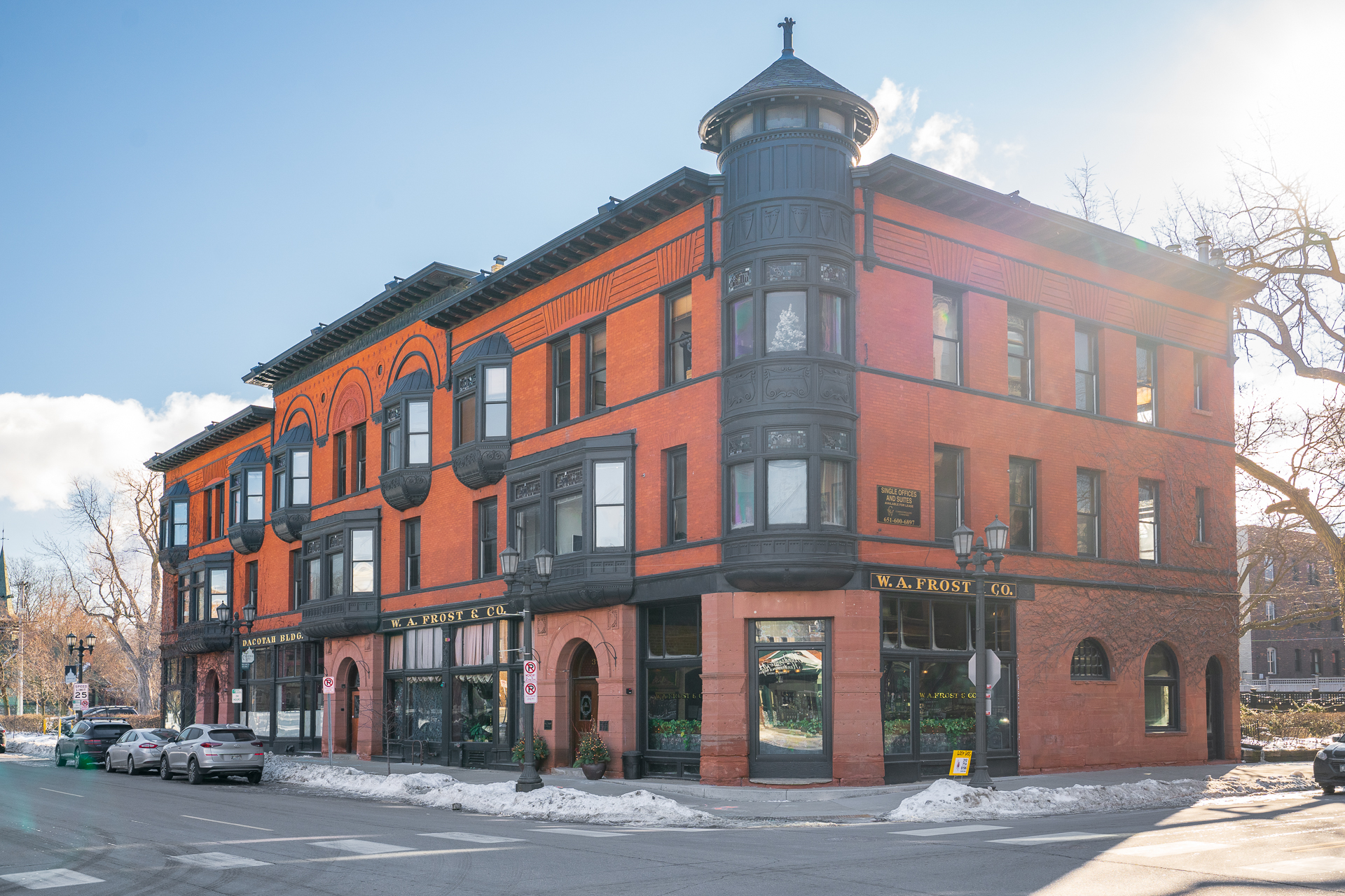 Ornate red brick and black accents define this historic building featuring W.A. Frost & Co.