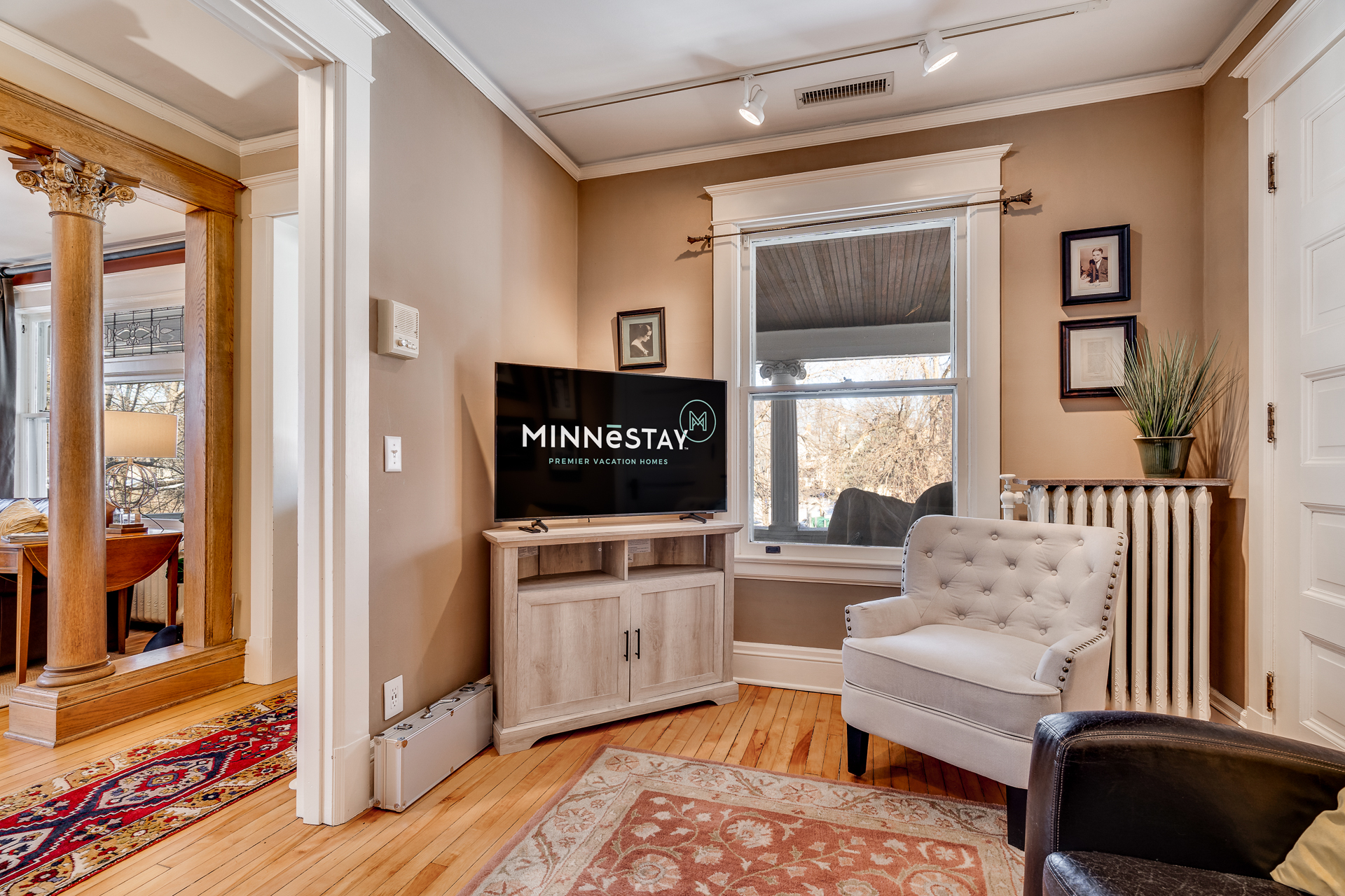 A cozy living room featuring a blend of modern and traditional design with natural light.