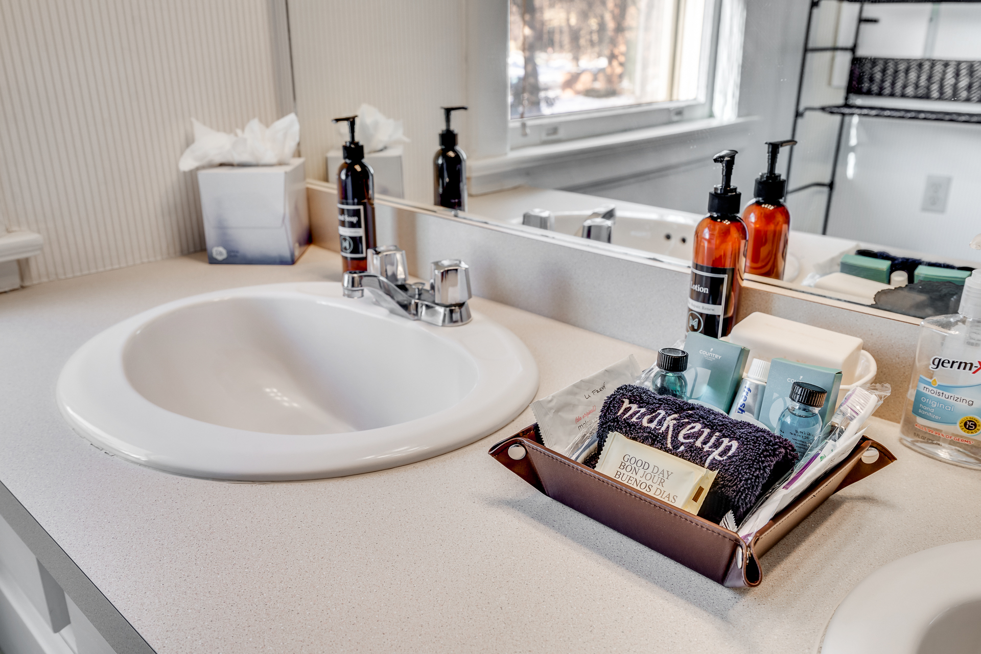 A neatly organized bathroom countertop with personal care items.