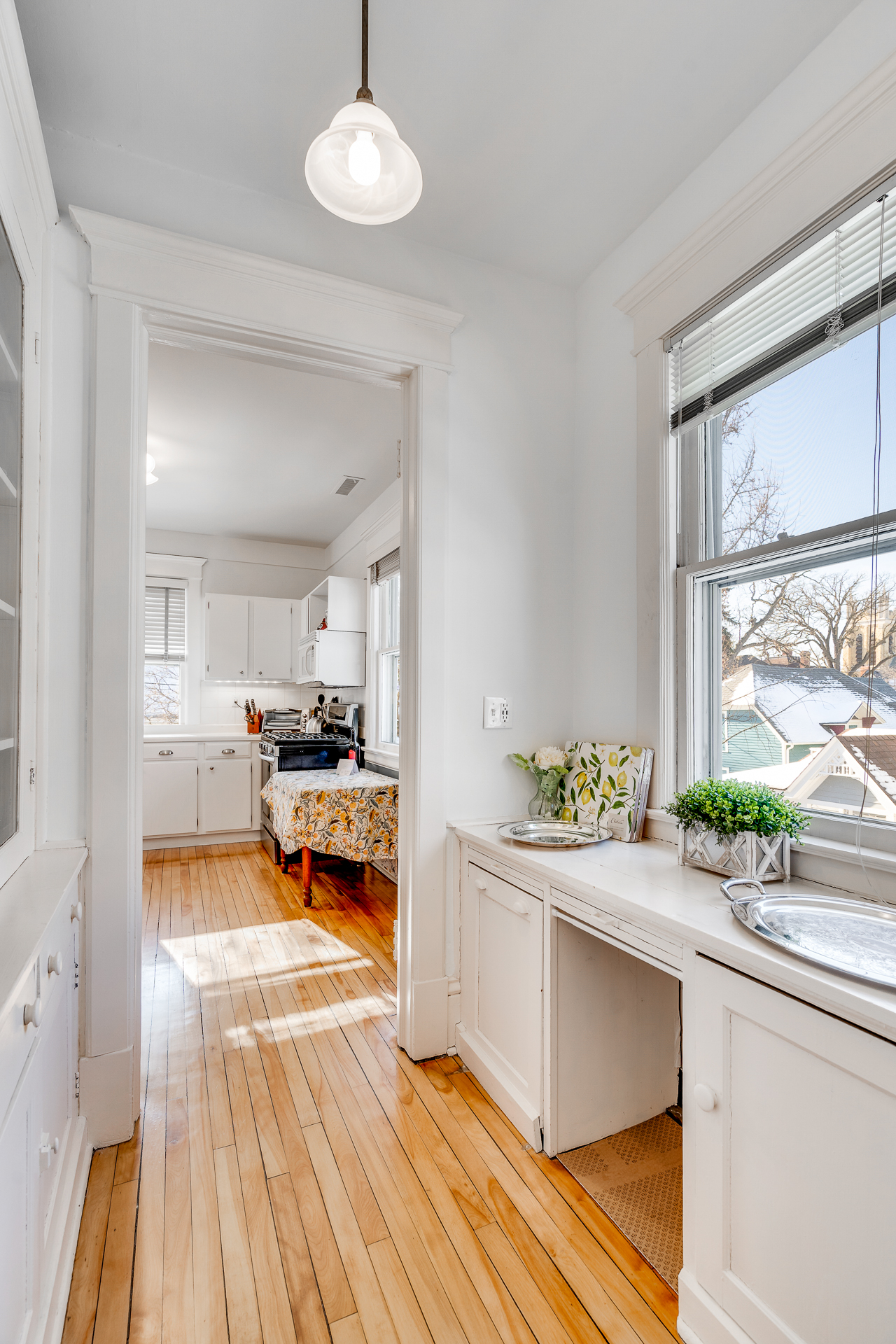 A bright and inviting kitchen with wooden floors and charming decor.