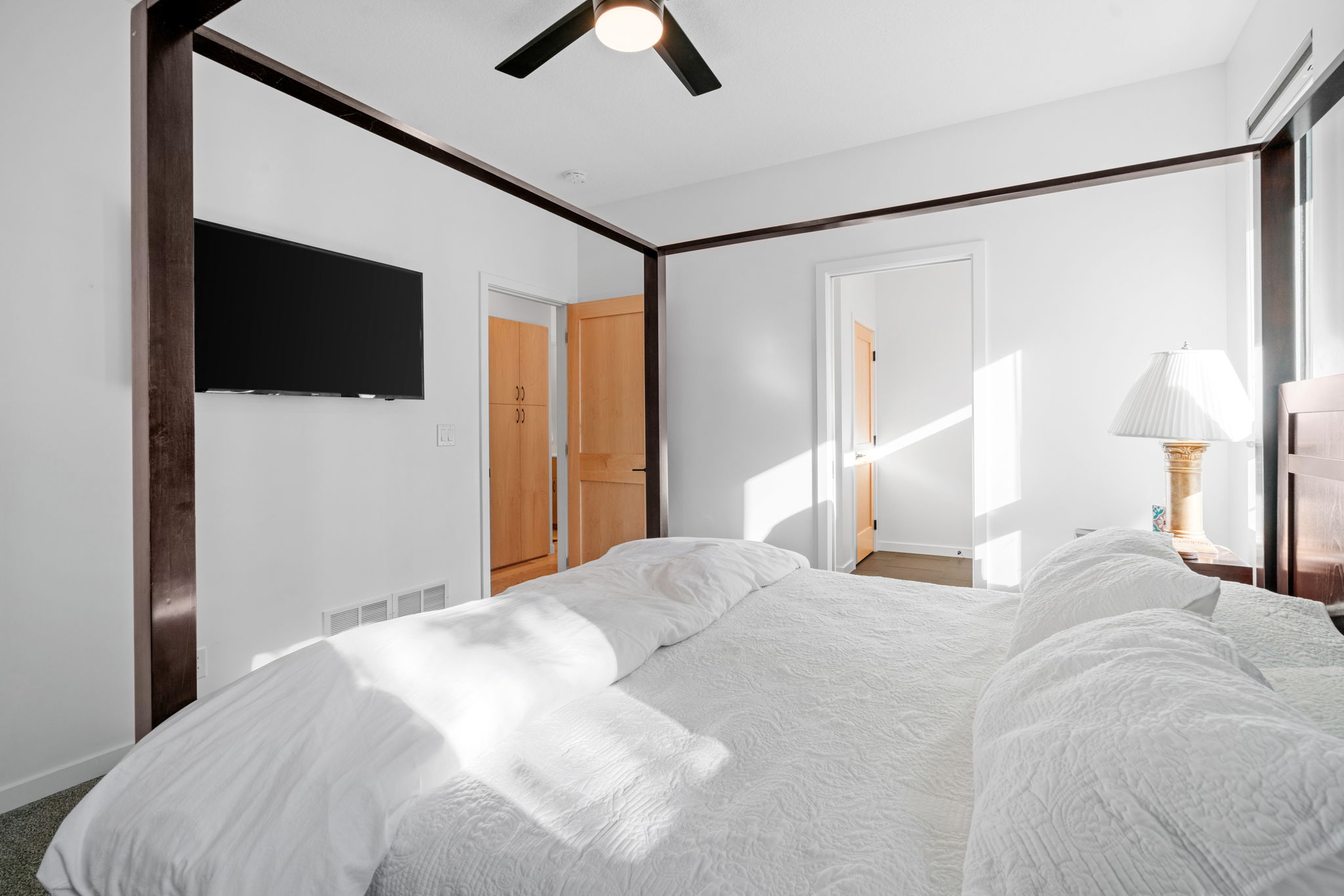 A bright and modern bedroom featuring a queen bed and stylish decor.