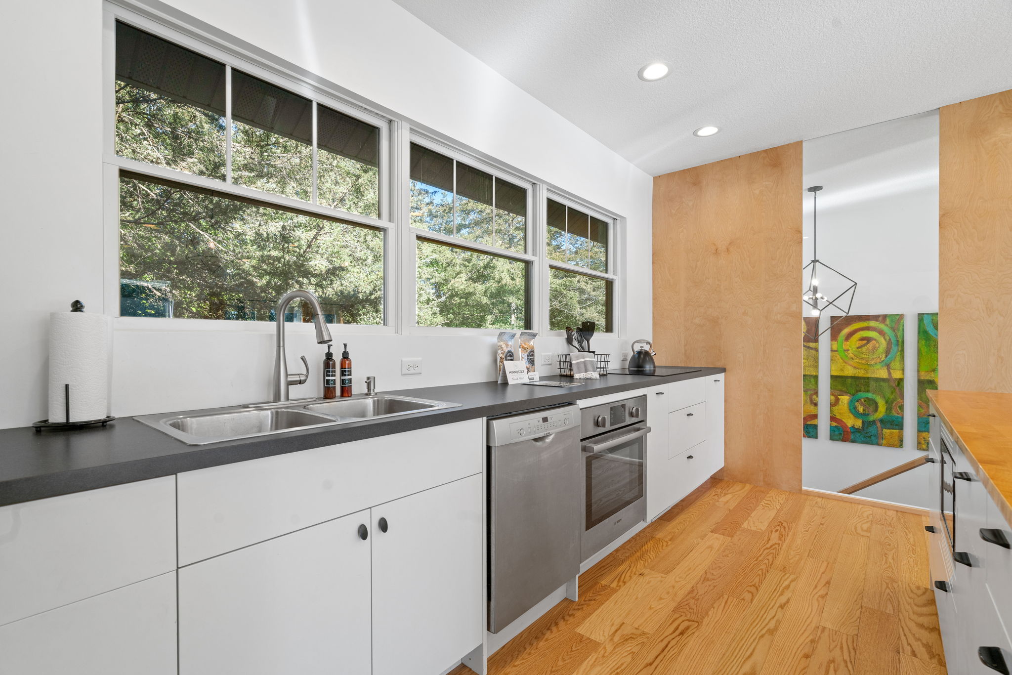 A sleek and modern kitchen with natural light and vibrant decor.