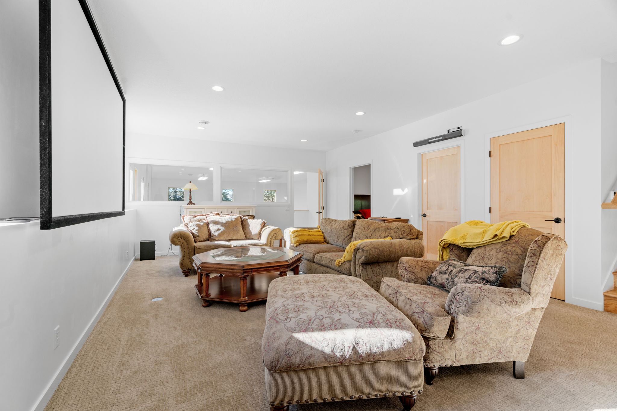 Cozy living area with ample seating and a projection screen.