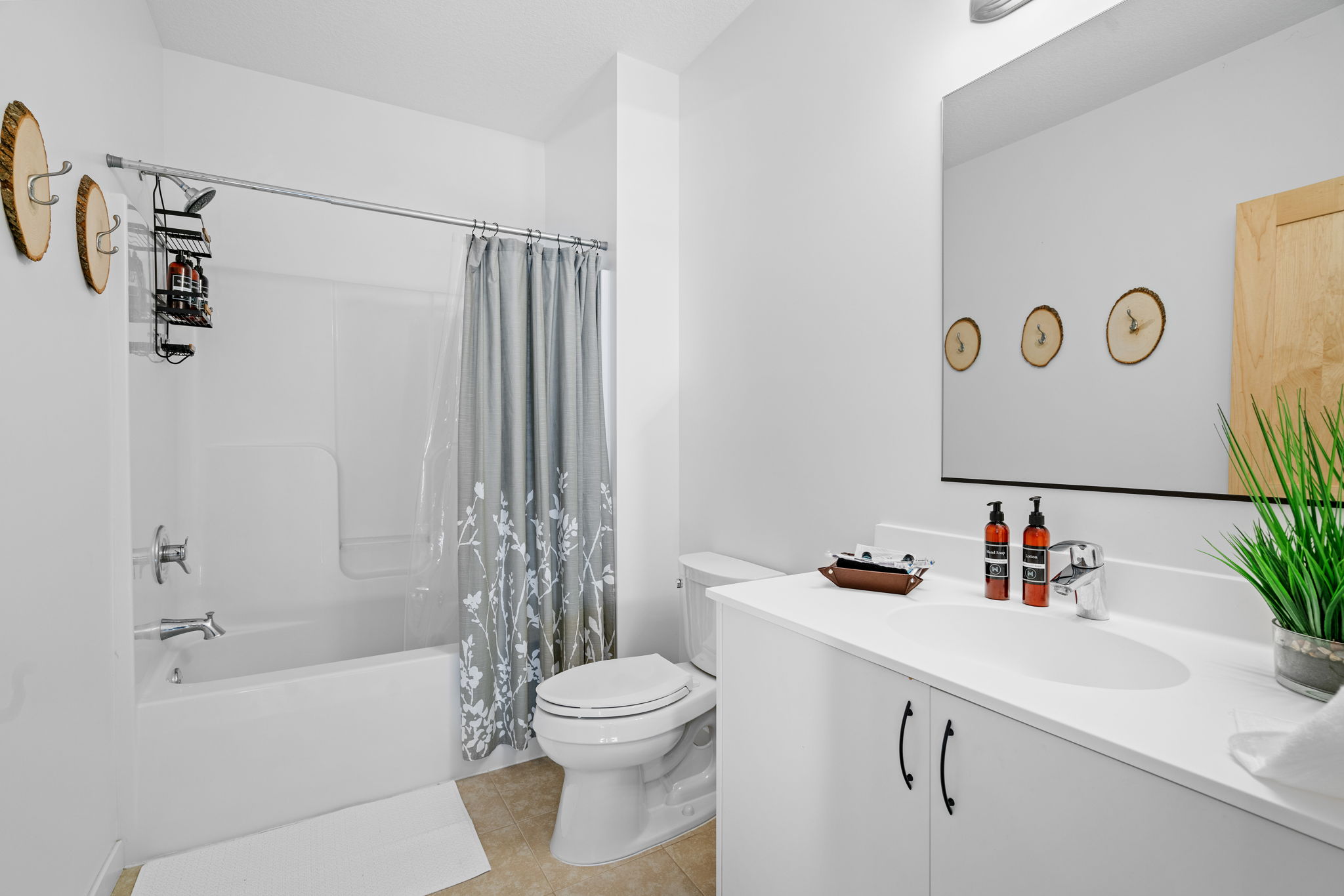 A modern and minimalist bathroom with floral accents and rustic decor.