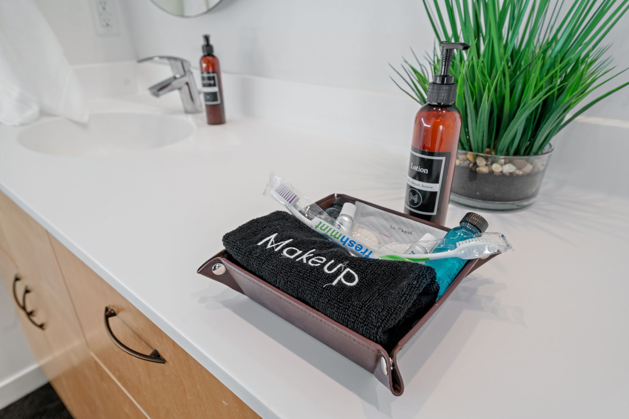 A neatly arranged bathroom countertop with personal care essentials.