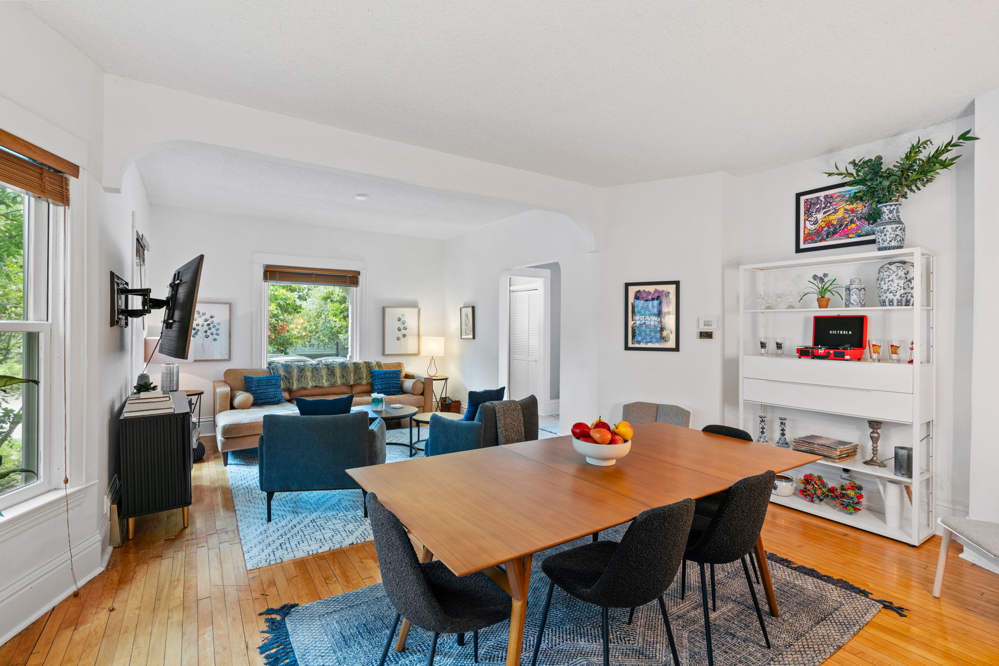 A cozy and modern open dining and living area with stylish decor and warm light.