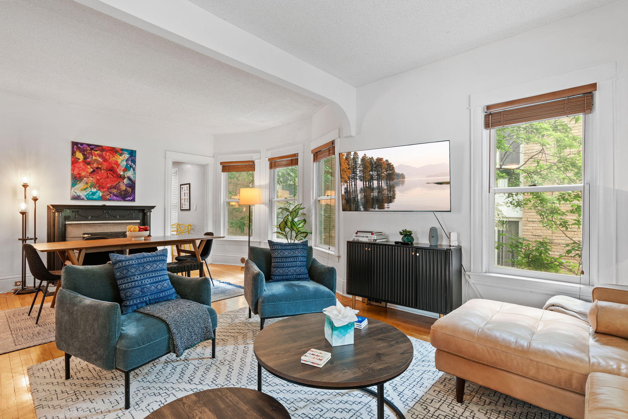 Bright and modern living room with stylish decor and vibrant art.