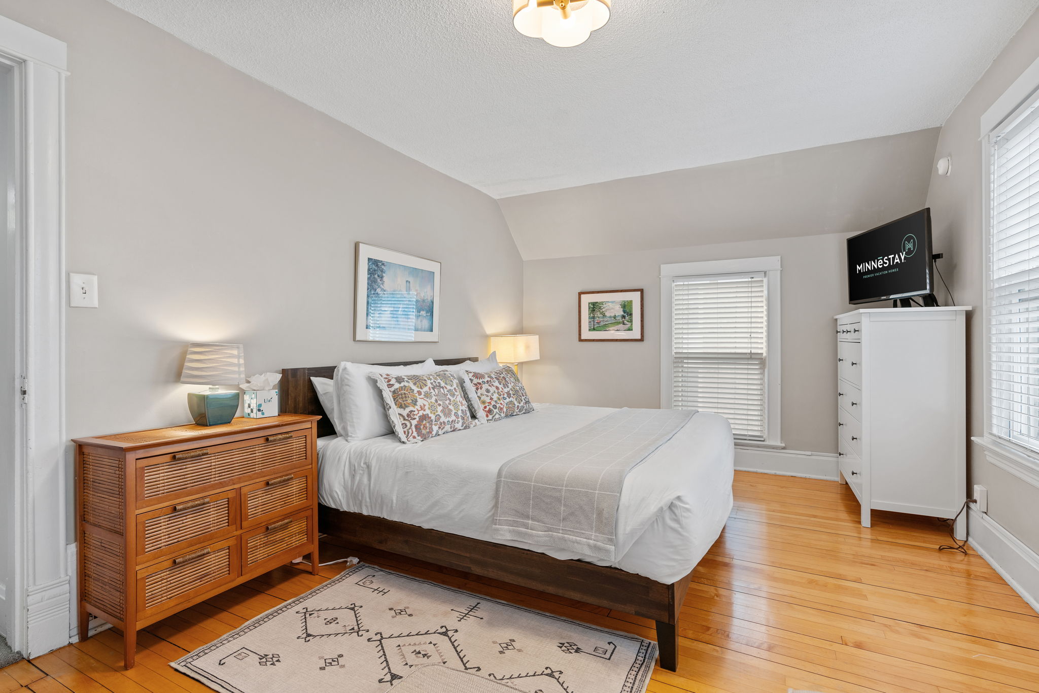 A bright and cozy bedroom featuring a comfortable bed and stylish furnishings.