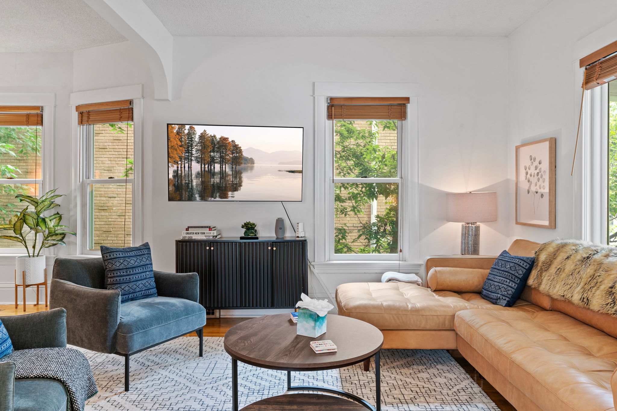 A cozy living room with modern decor and abundant natural light.