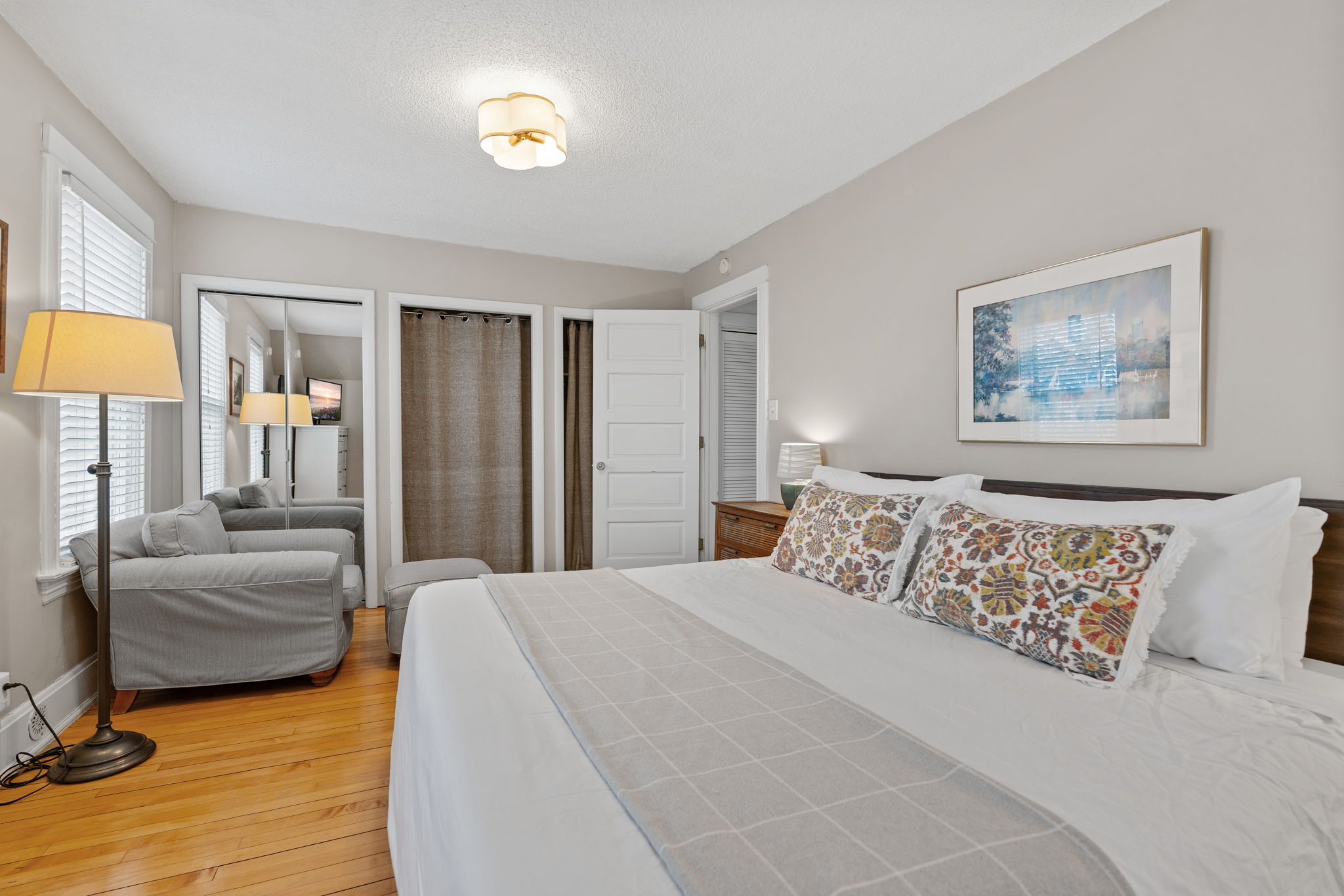 A cozy and inviting bedroom with floral accents and warm wooden elements.