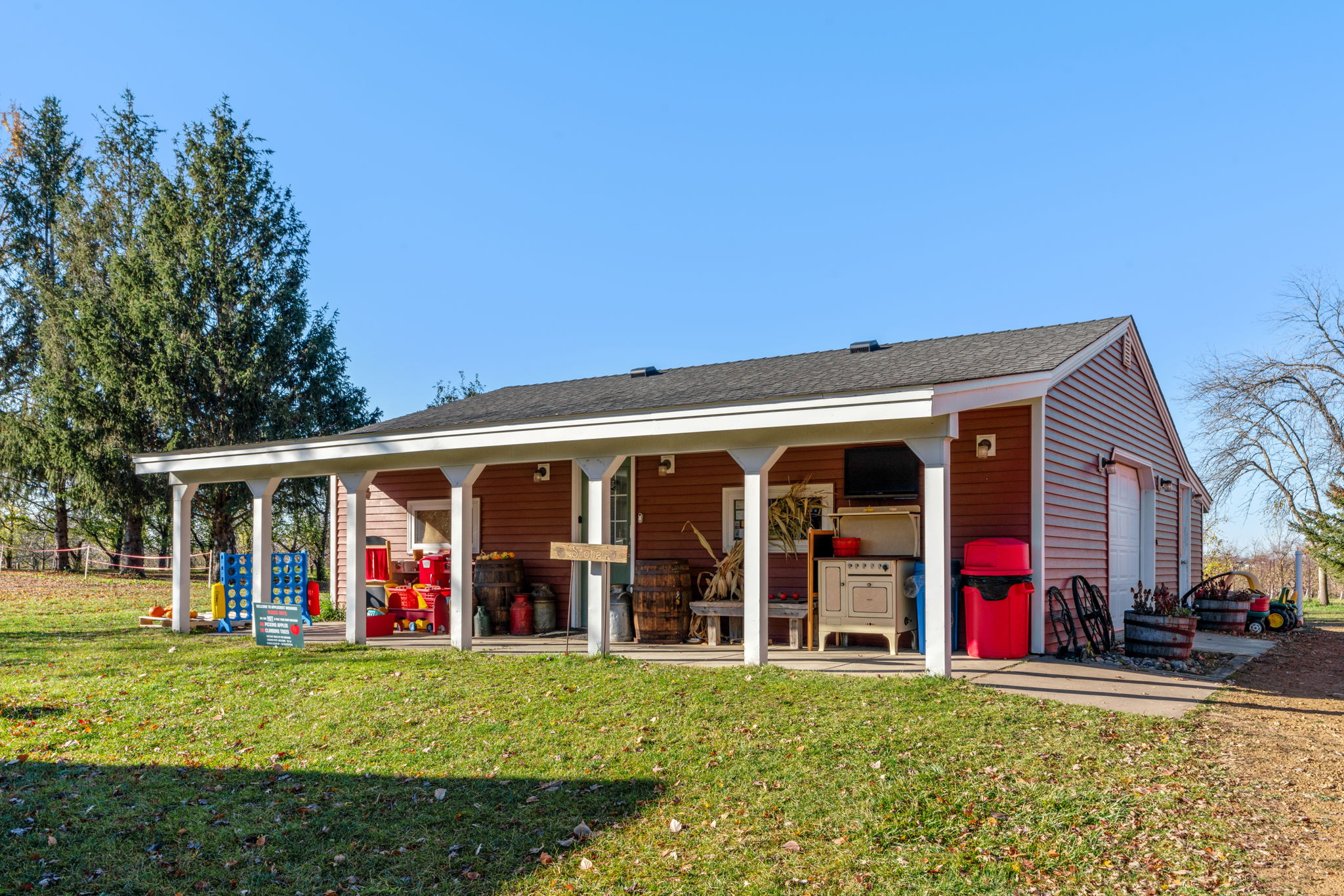 A cozy outdoor space featuring a rustic building and colorful play items.