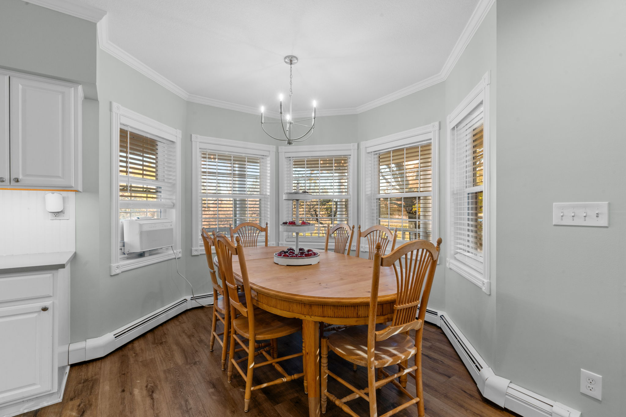 Cozy dining area with a wooden table and plenty of natural light.