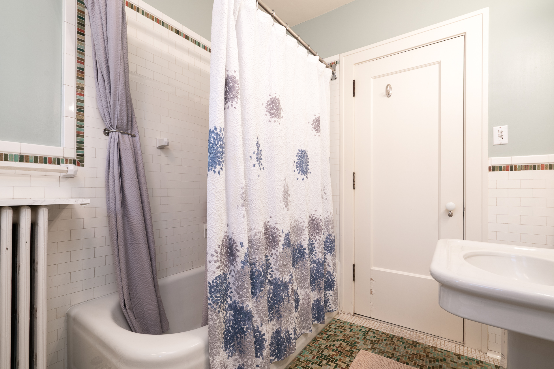 A cozy bathroom featuring a blend of traditional and modern design elements.