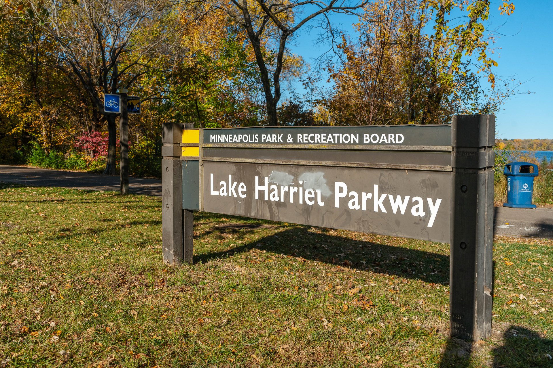 Lake Harriet Parkway sign amidst autumn foliage.