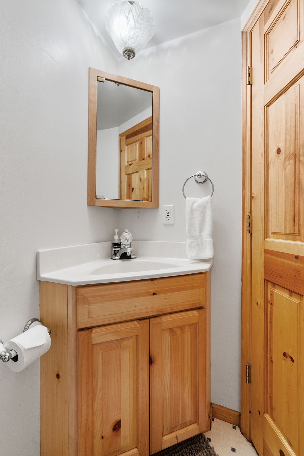 A cozy and rustic bathroom with wooden accents and modern fixtures.
