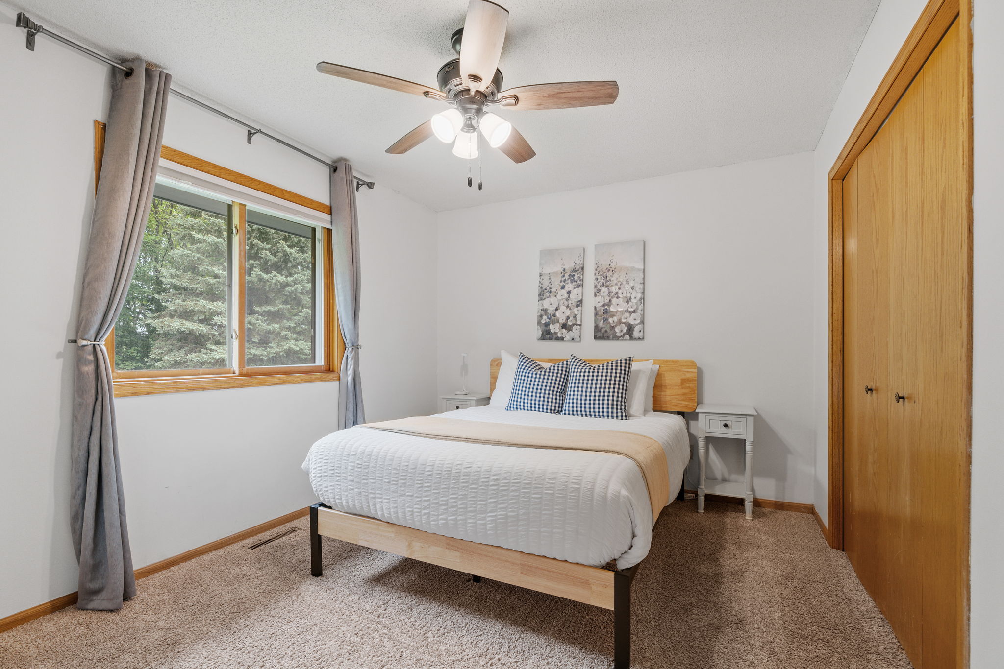 A cozy and modern bedroom with a queen-size bed and natural light.
