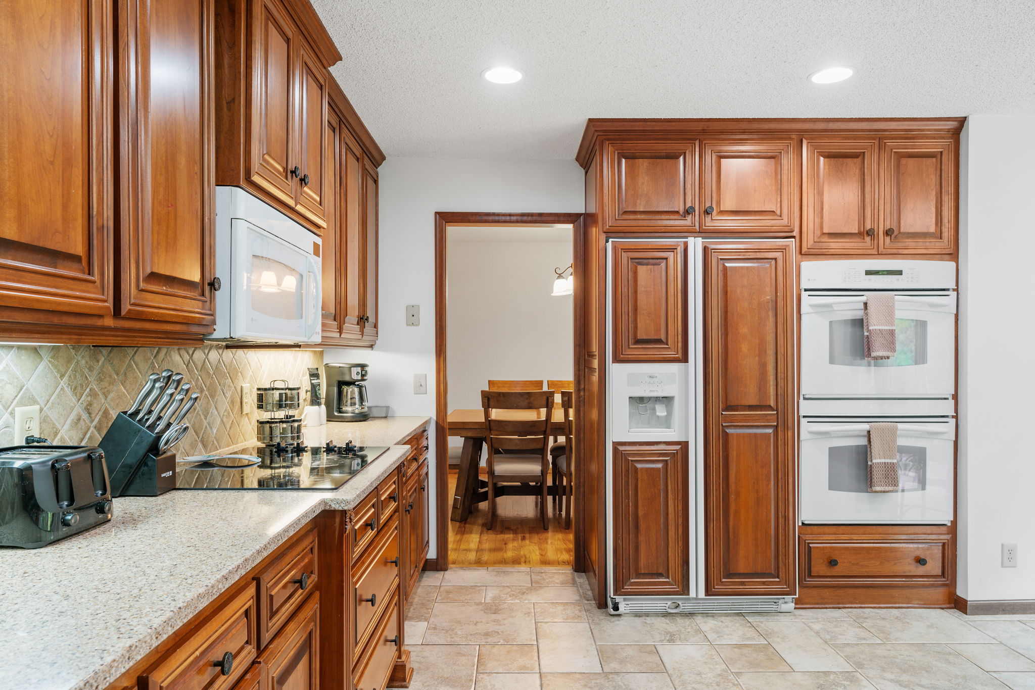 A warm and inviting kitchen with rich wooden cabinetry and modern appliances.