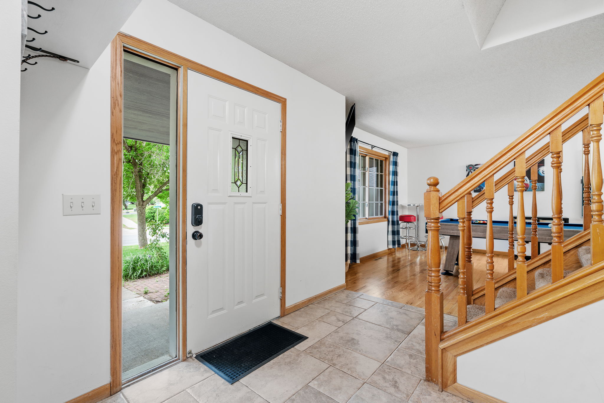 Welcoming entryway with a view of lush greenery outside.