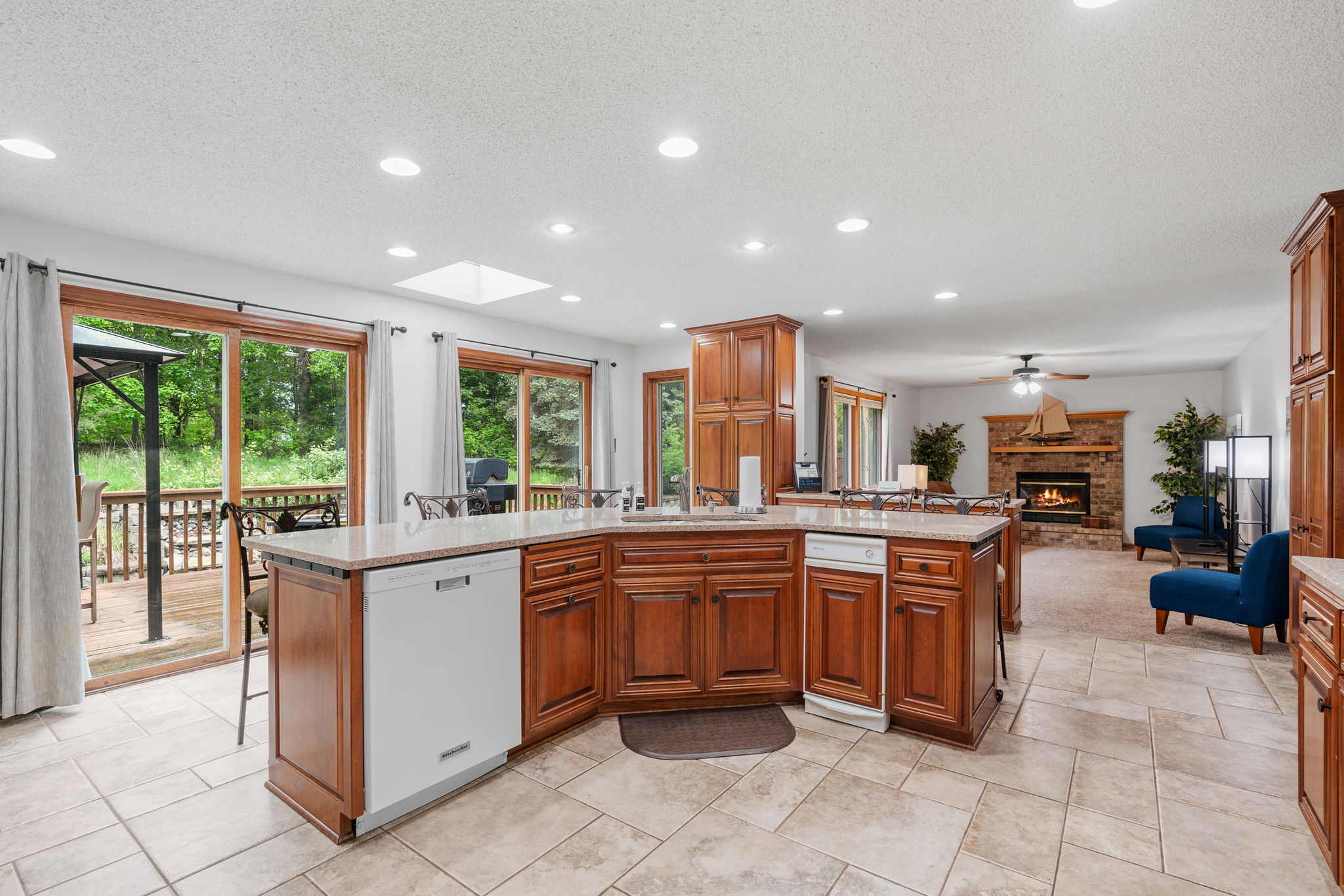A beautiful kitchen with wooden cabinetry and a view of the outdoors.