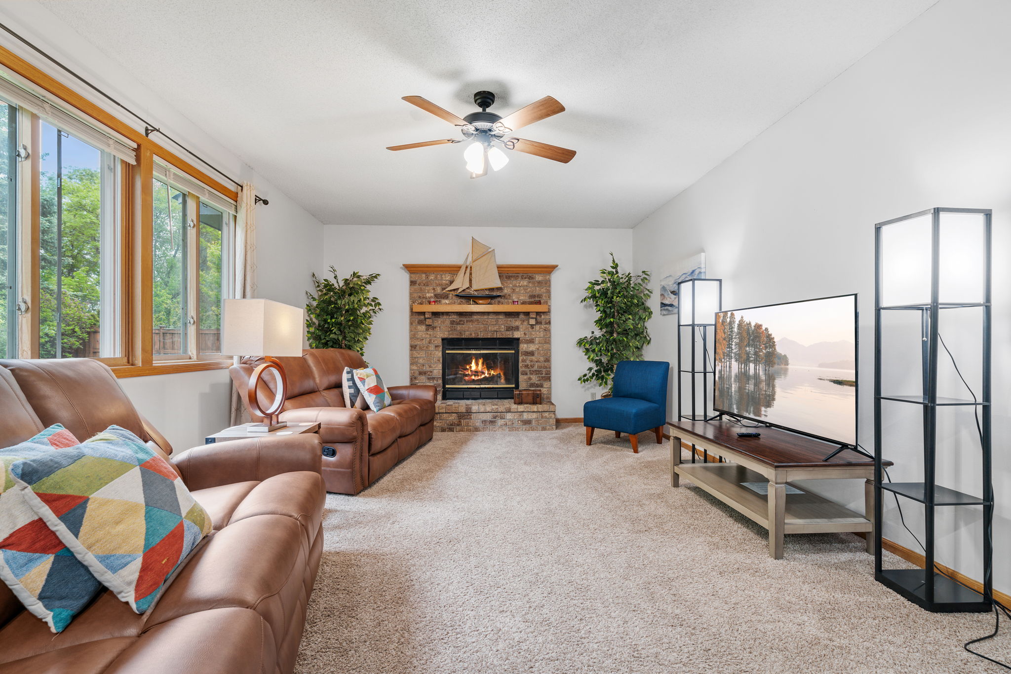 A cozy living room with a fireplace and modern decor.