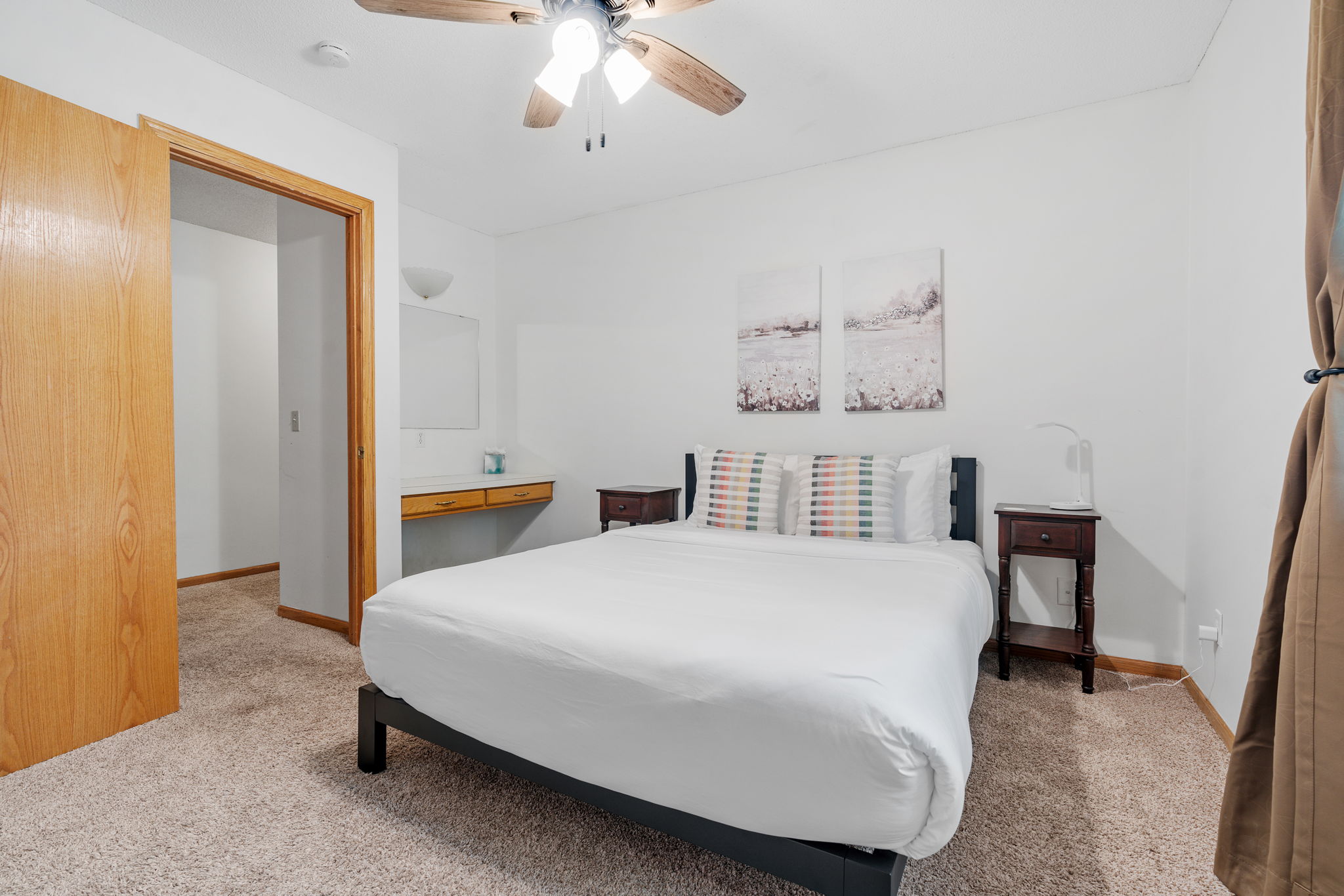 A serene and inviting bedroom featuring a modern bed and minimalist decor.