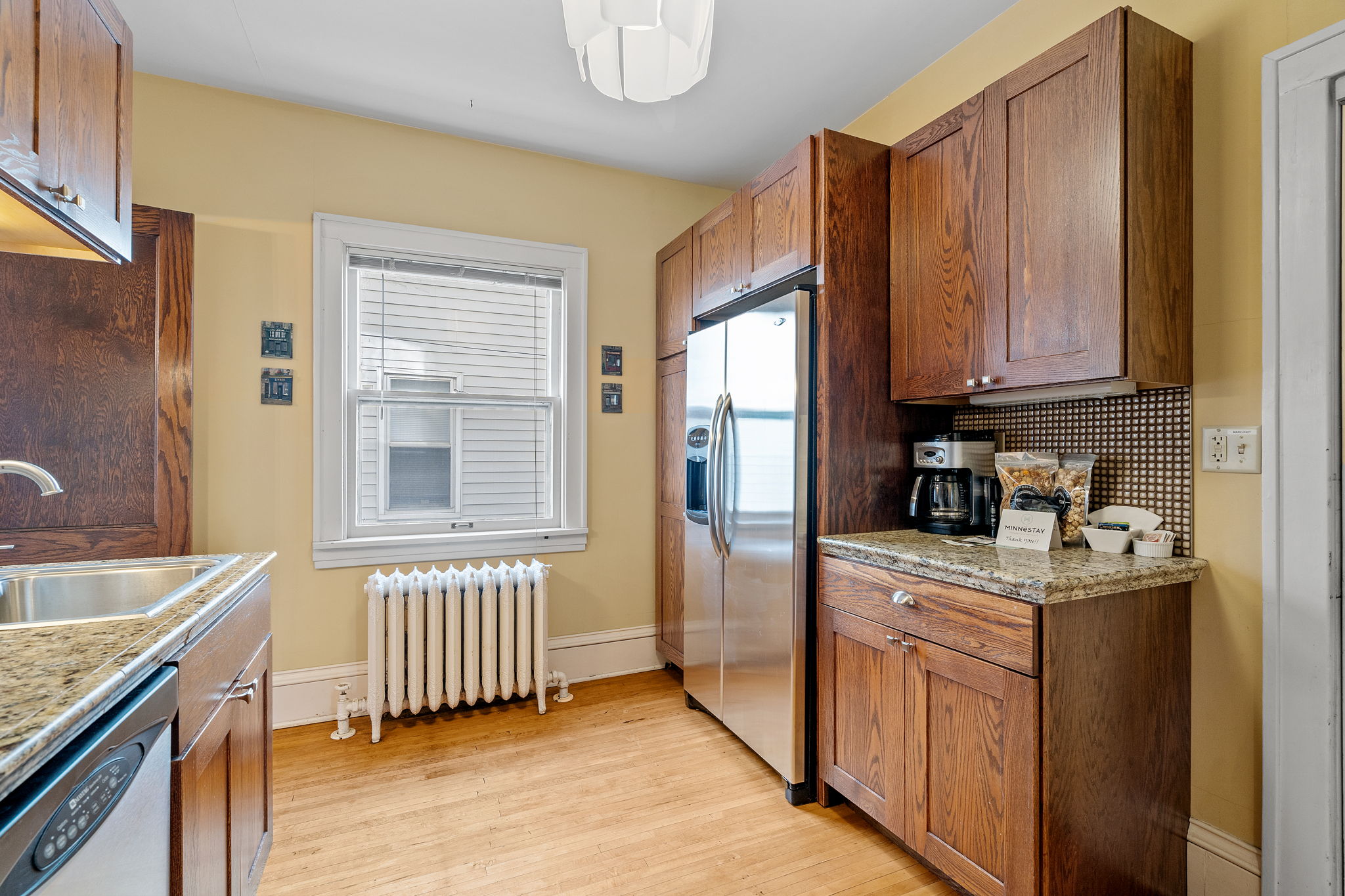 A cozy kitchen featuring warm wood cabinetry and modern appliances.