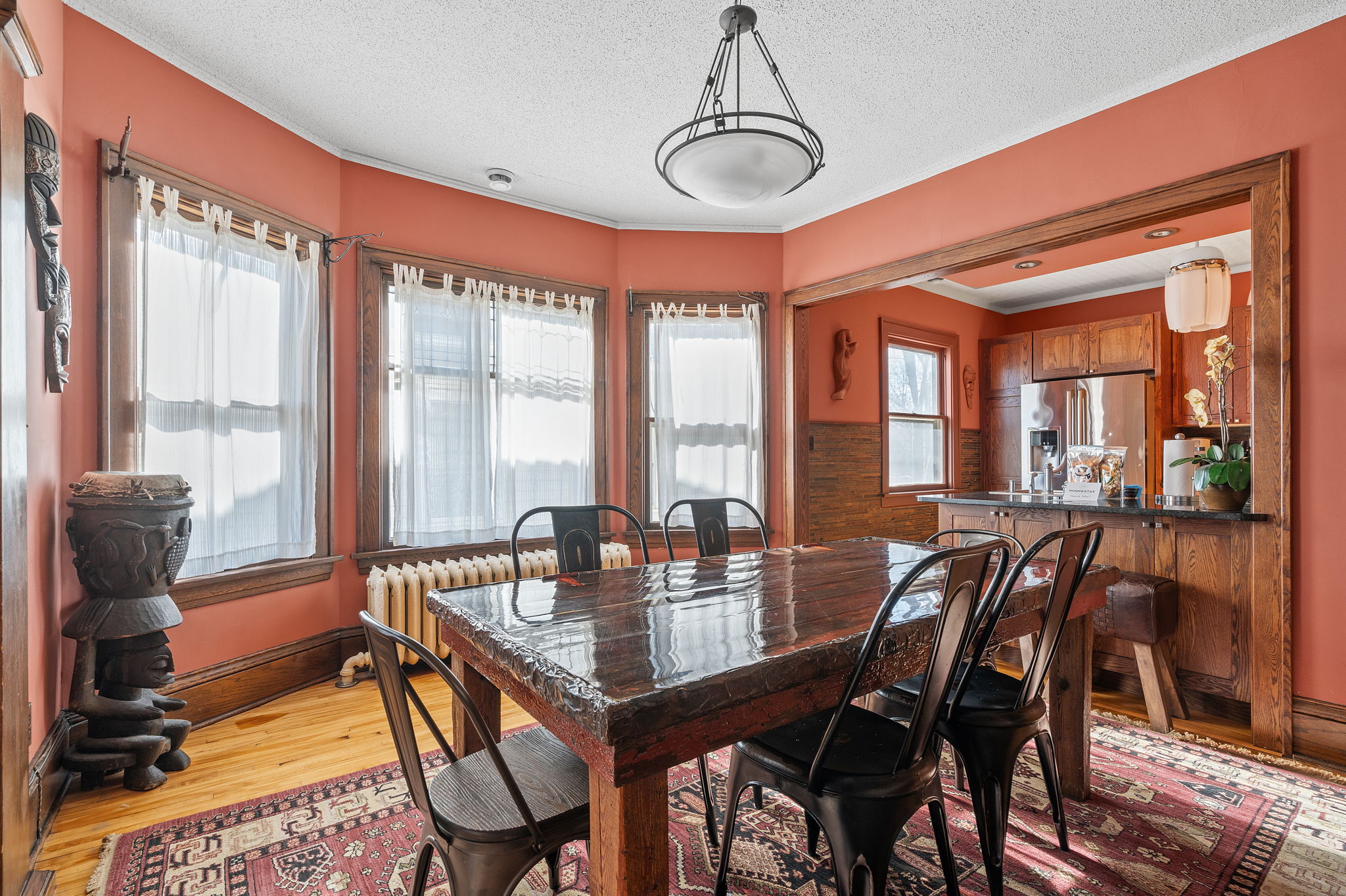 A cozy dining area featuring a rustic wooden table and modern accents.
