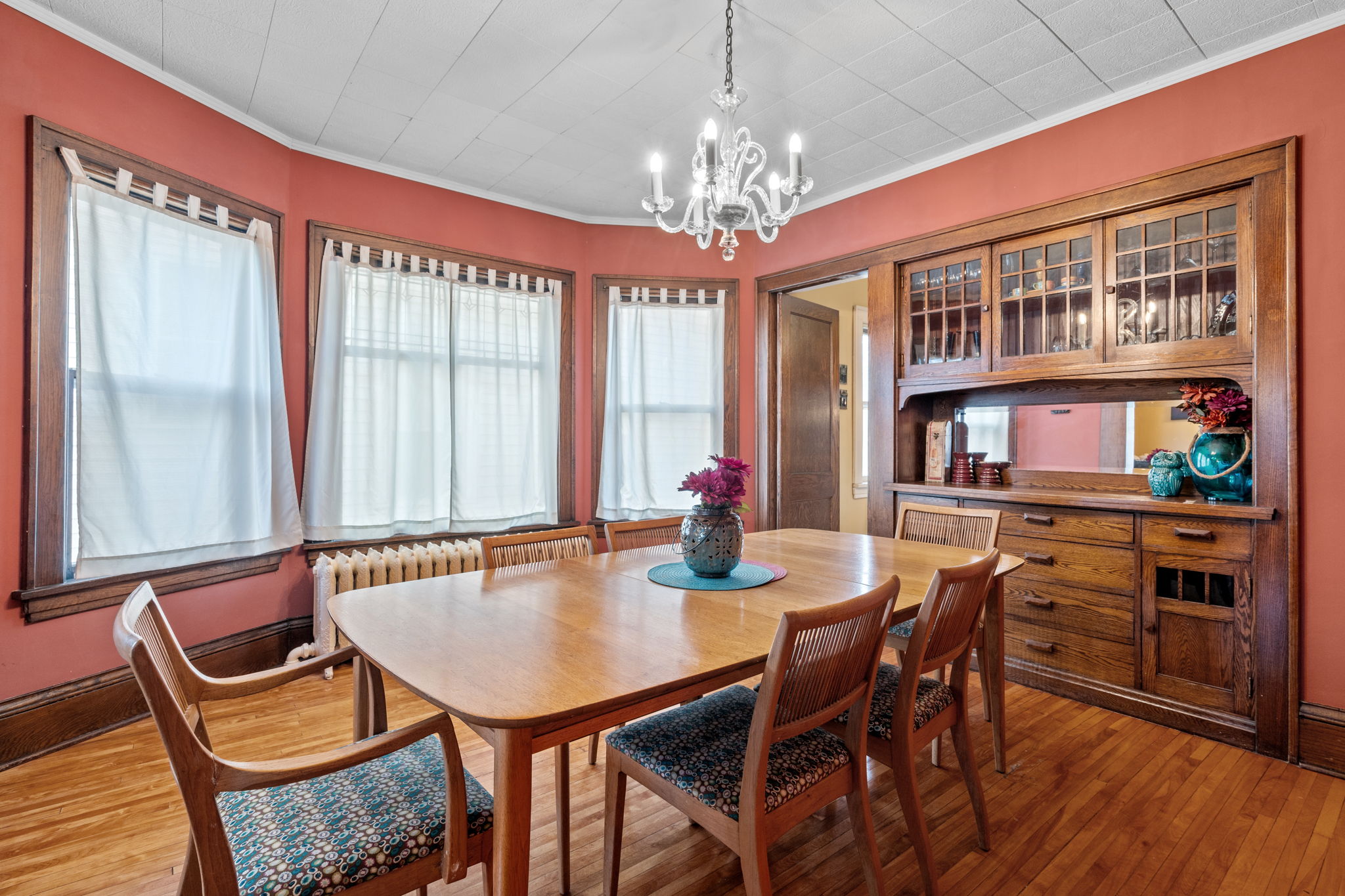 A cozy and inviting dining room featuring an elegant chandelier and wooden furnishings.