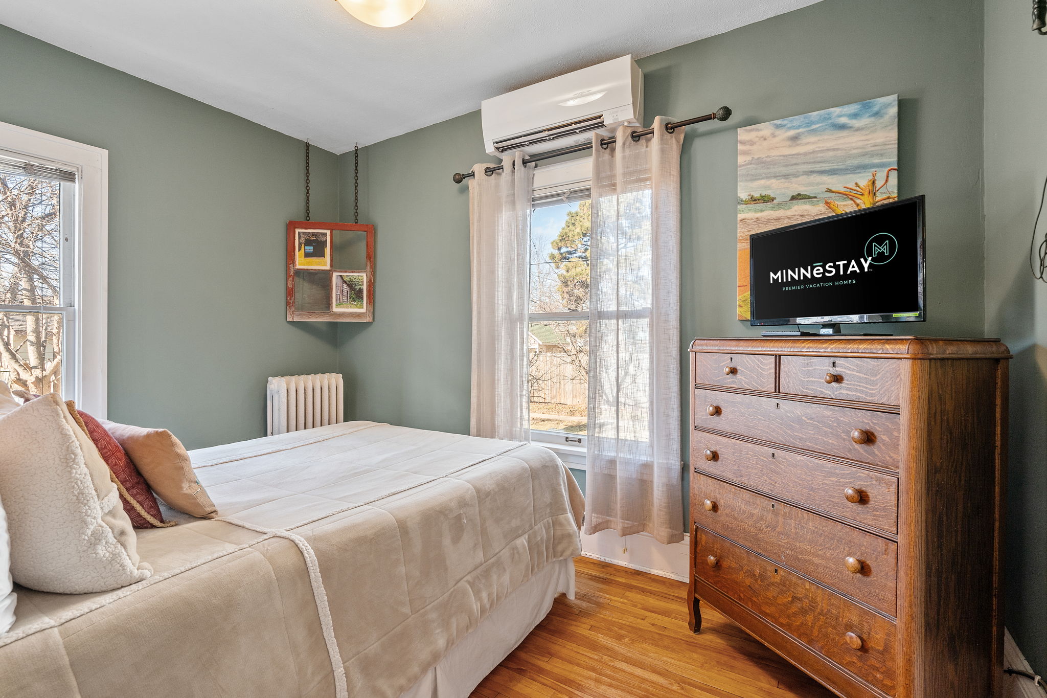 A stylish bedroom showcasing cozy decor and natural light.