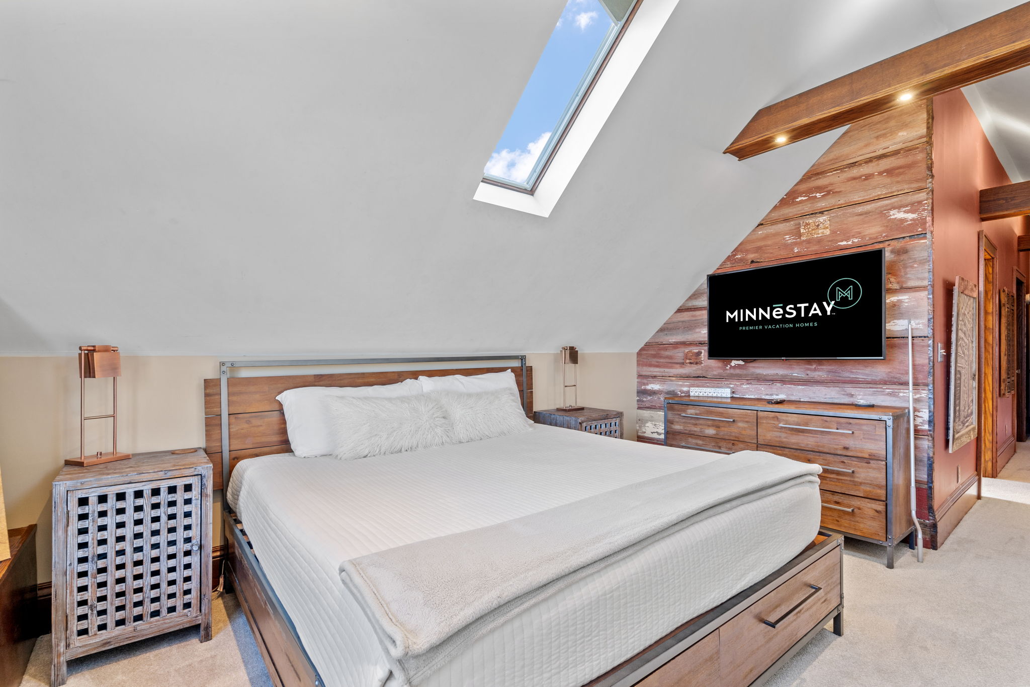 Modern bedroom with rustic accents and natural light.