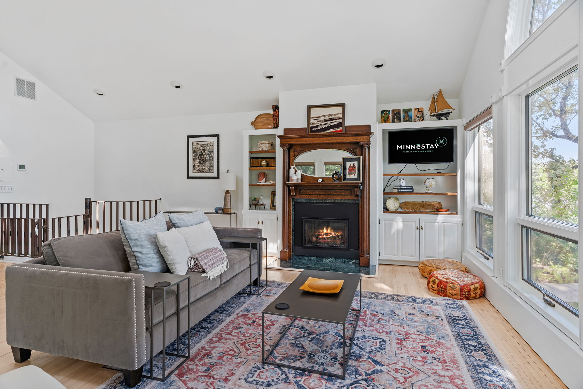 A cozy living room featuring a fireplace and modern decor.