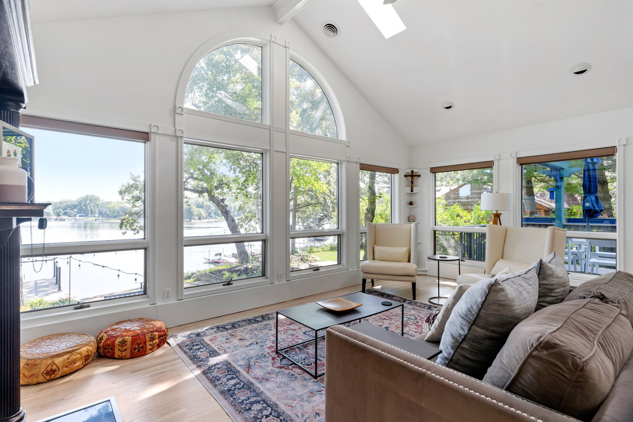 A bright and airy living room with views of a serene lake.