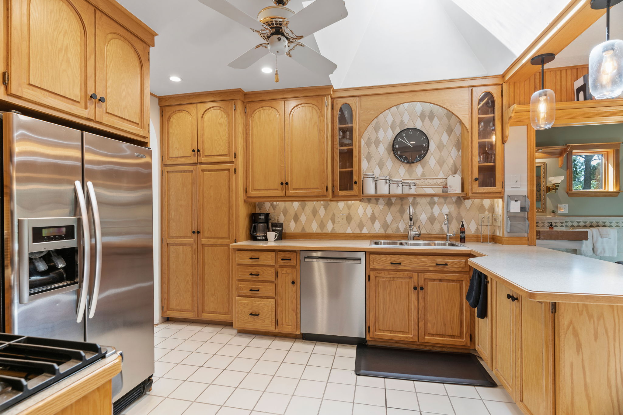 Spacious and stylish kitchen with oak cabinetry and stainless steel appliances.