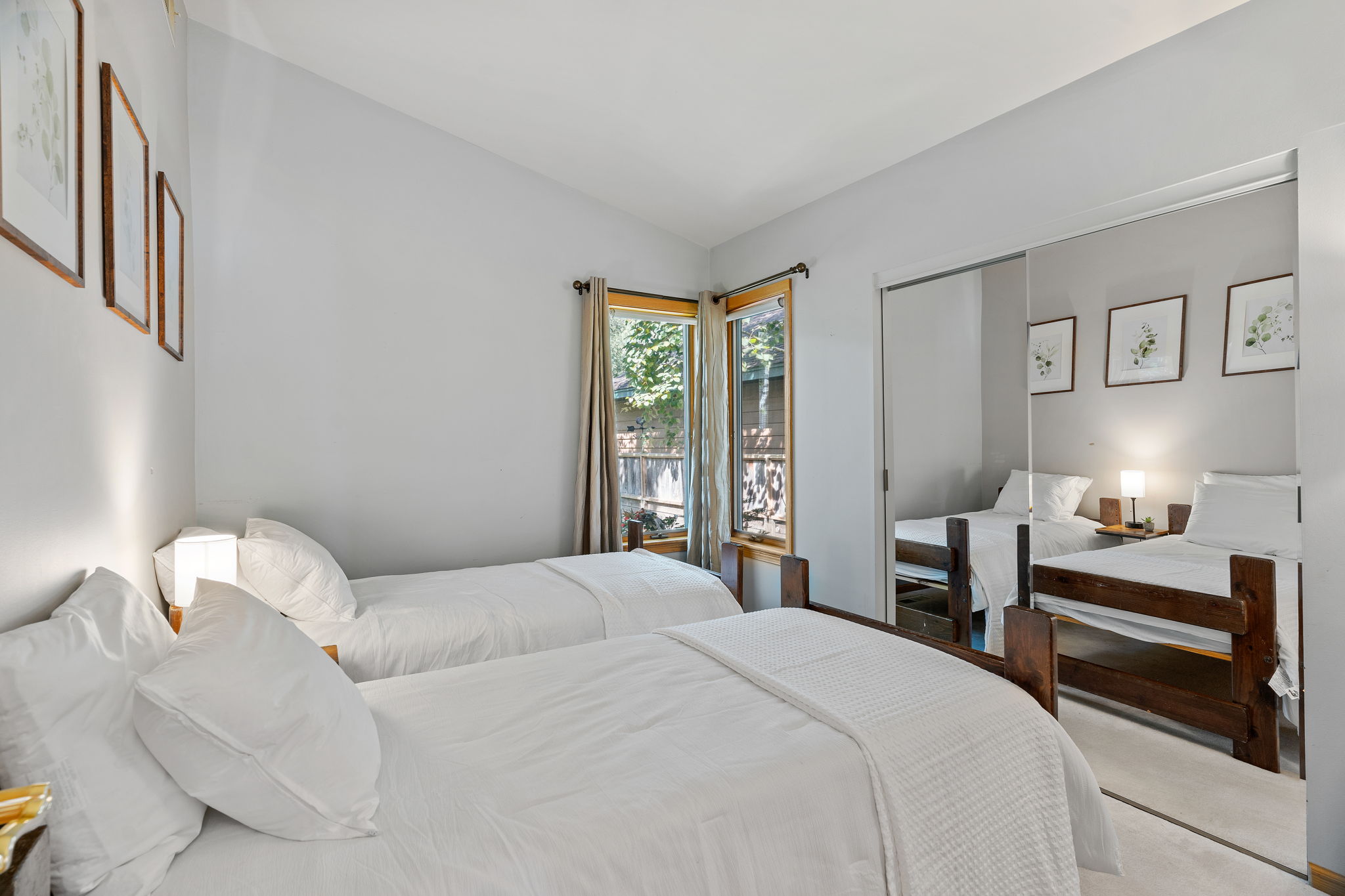 A cozy bedroom with twin beds and warm natural light.