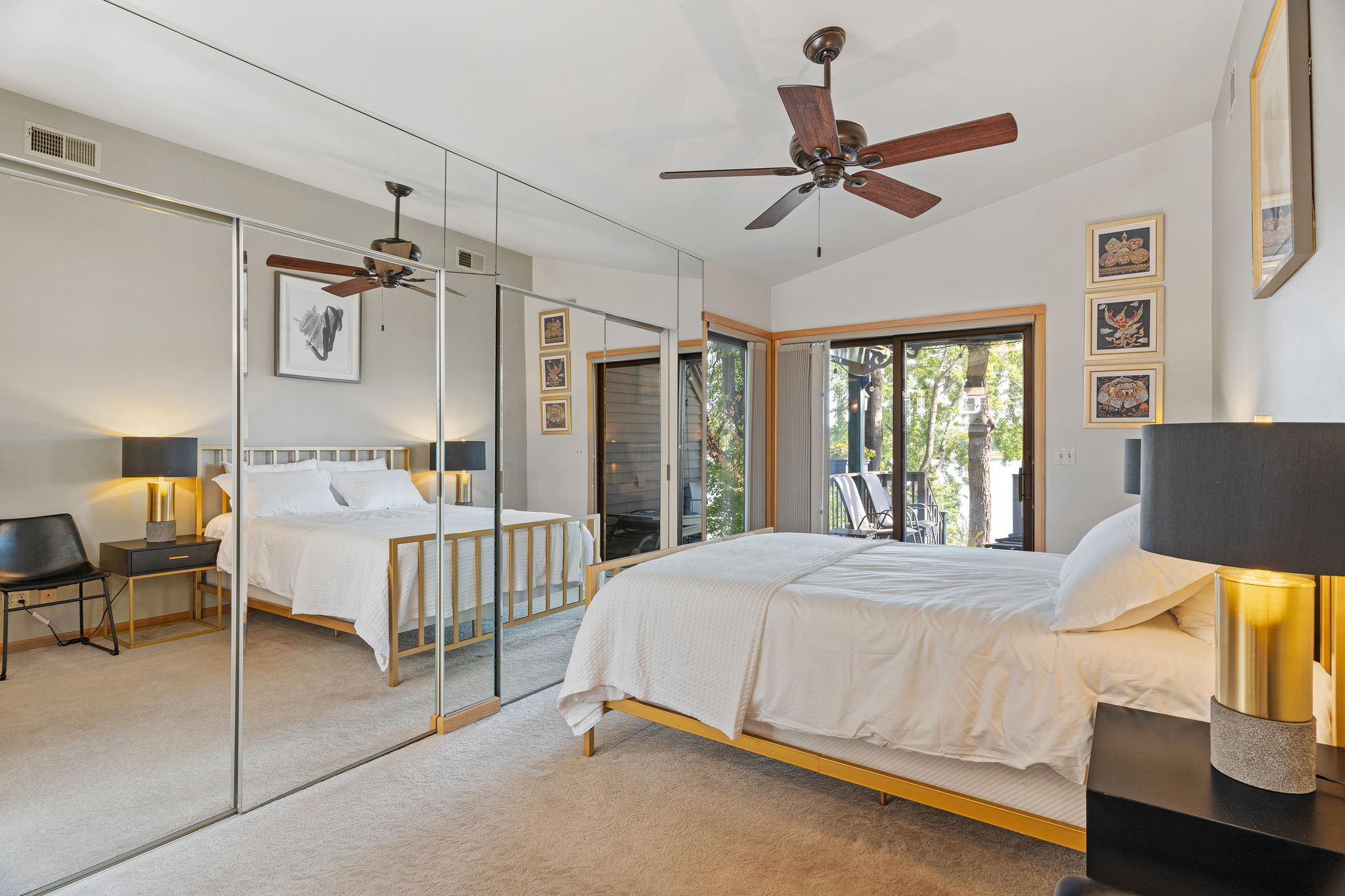A modern bedroom featuring a comfortable bed and a balcony view.