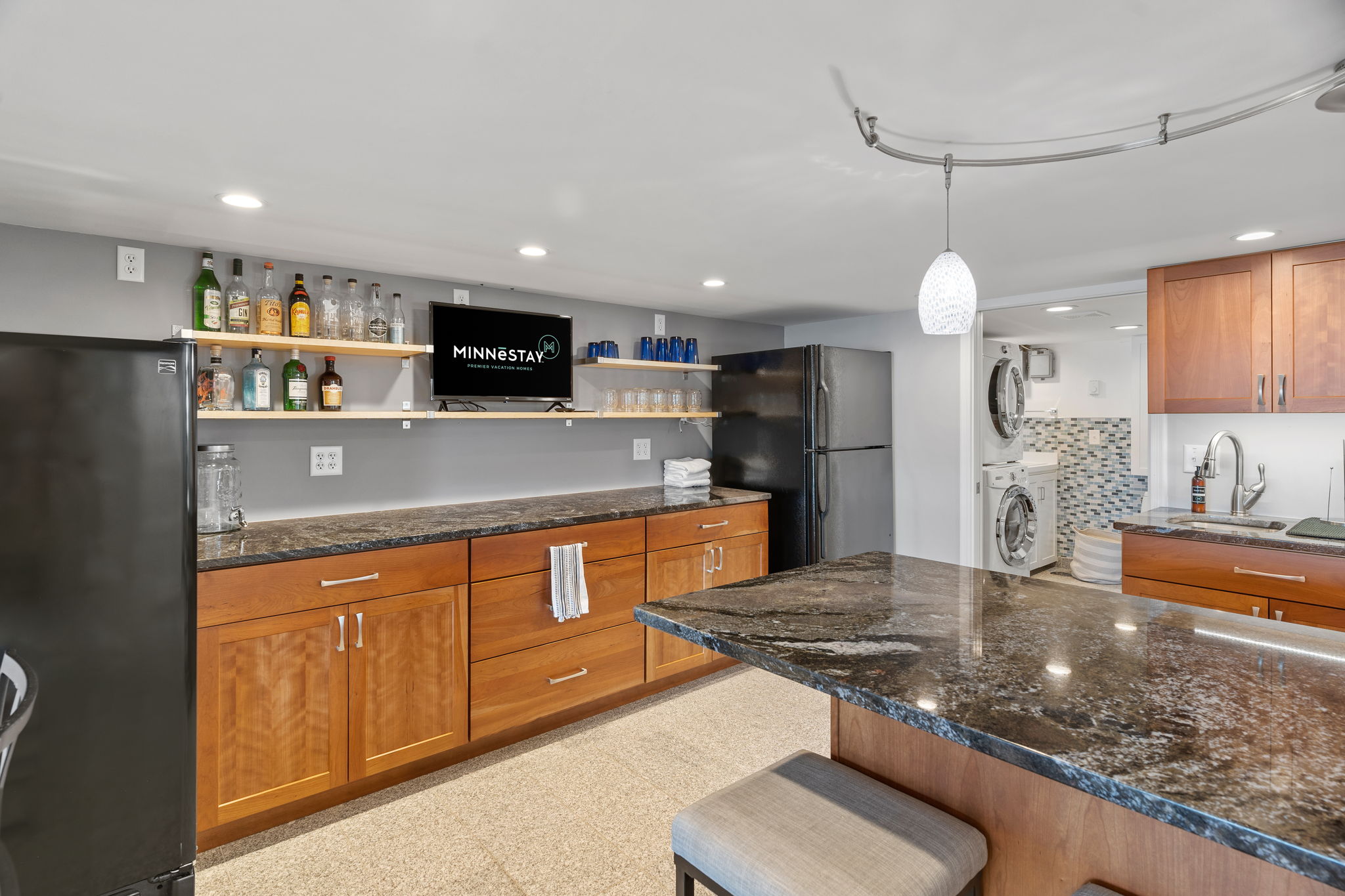 A modern kitchen with sleek granite countertops and a cozy dining area.
